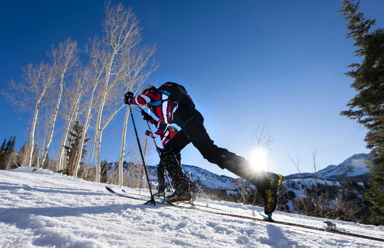 Skimo athletes Landon Jakob and McCall Birkinshaw take off after performing a transition as they demonstrate the relatively new sport during a short workout in Alta on Tuesday, Jan. 20, 2026.