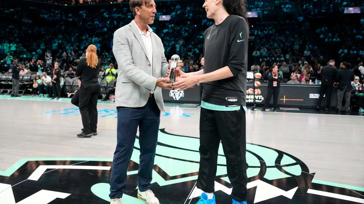 The Associated Press' Global Sports Editor Josh Hoffner presents the Greatest Player award to New York Liberty forward Breanna Stewart ahead of a WNBA basketball game against the Dallas Wings, Tuesday, July 7, 2026, in New York.