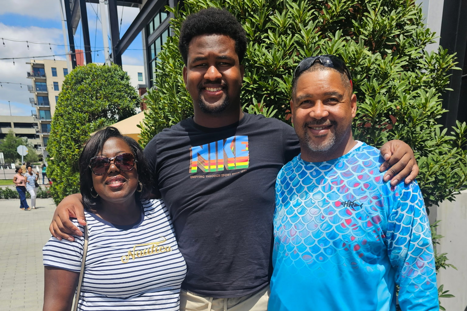 Calvin Dickey Jr., center, poses for a photo with his father, Calvin Dickey Sr., and mother, Nicole Dickey, in Tampa, Fla., on March 31, 2024. 