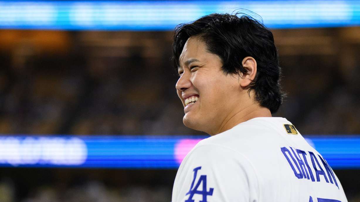 Los Angeles Dodgers' Shohei Ohtani smiles during the eleventh inning of a baseball game against the Colorado Rockies in Los Angeles, Monday, July 6, 2026.