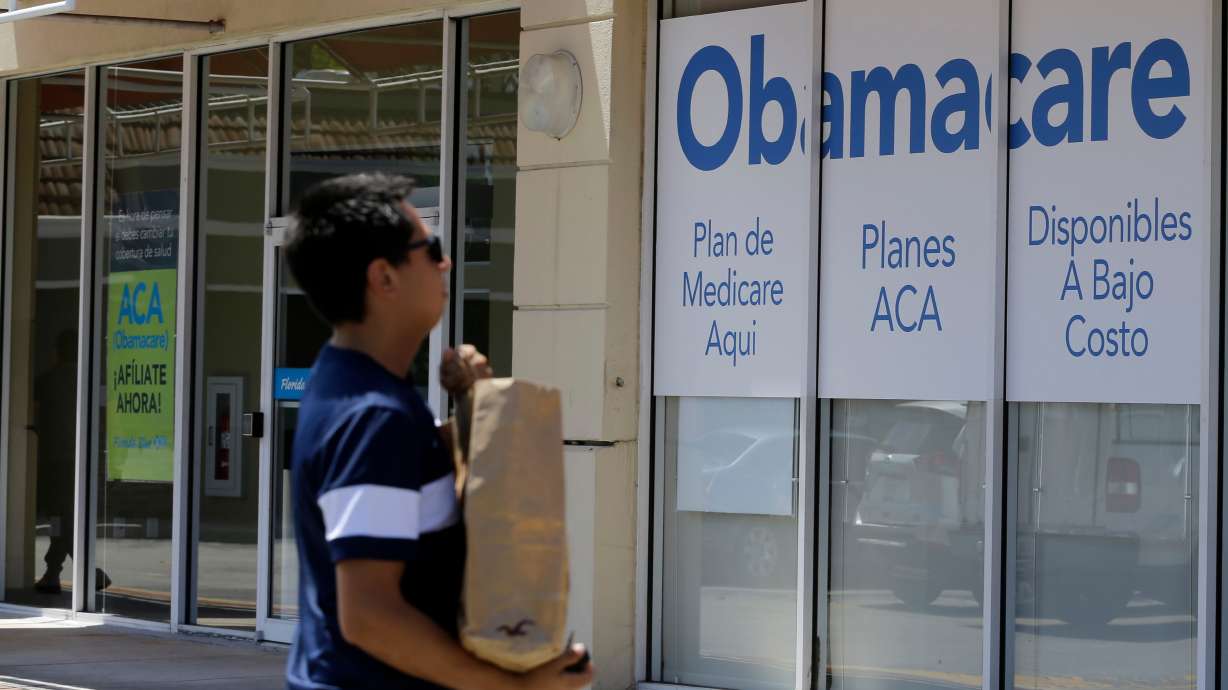A man walks by an healthcare insurance office in Hialeah, Fla., July 27, 2017. Obamacare premiums surged this year. A new analysis shows it's likely to happen again in 2027.