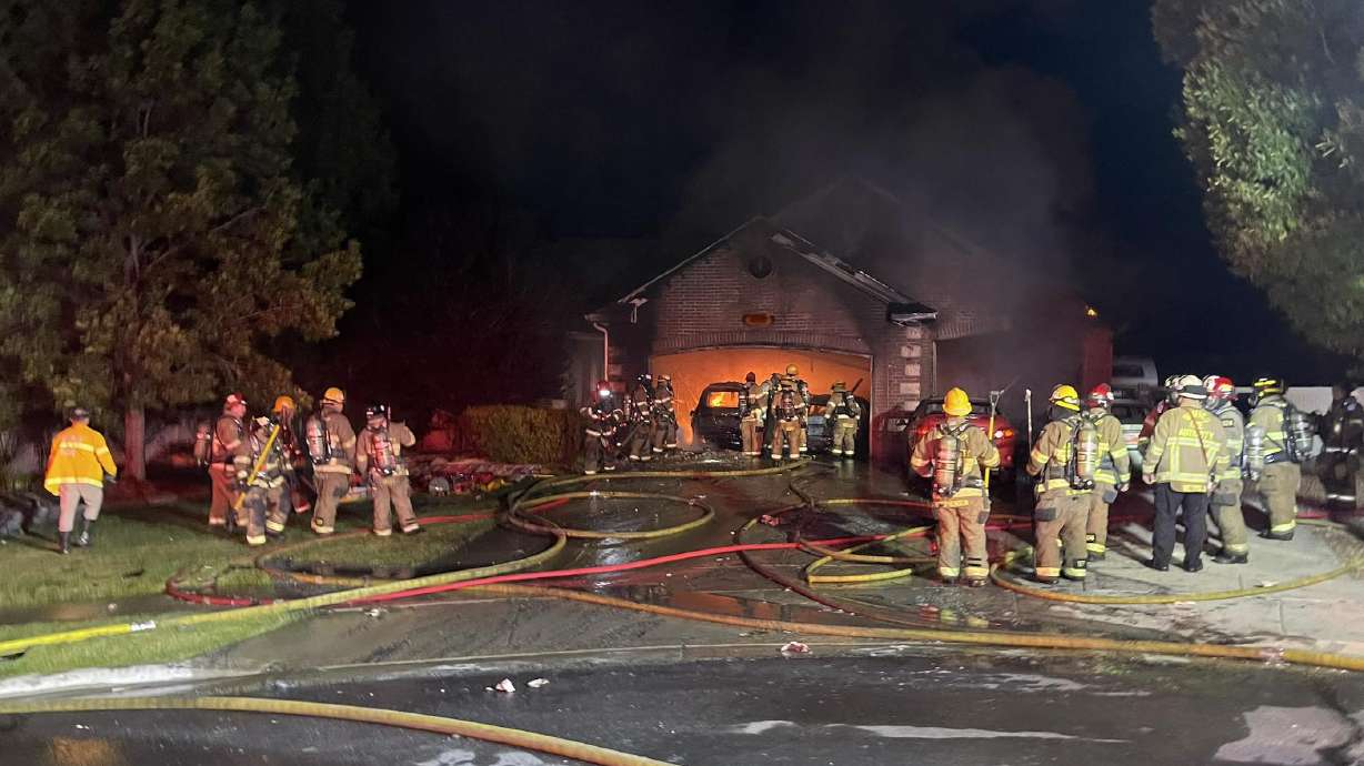 Fire crews are shown at the scene of a house fire in Herriman just after midnight on Wednesday.