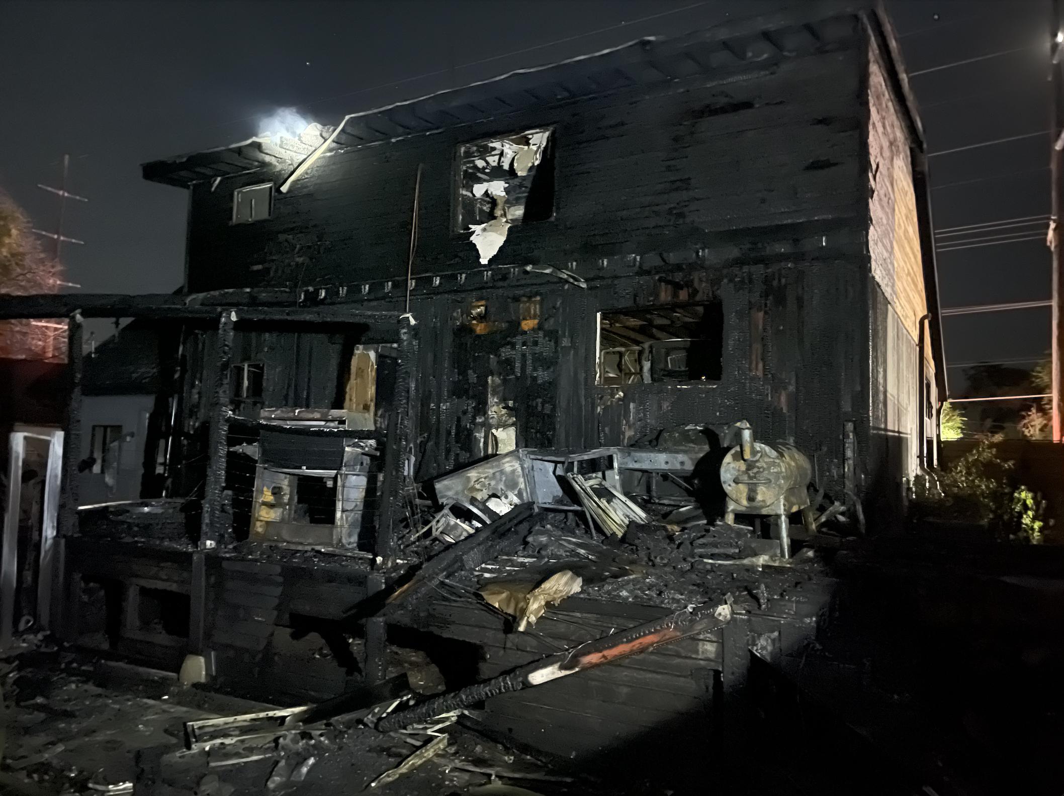 A home in Millcreek is pictured after it burned in a house fire just after midnight on Wednesday.