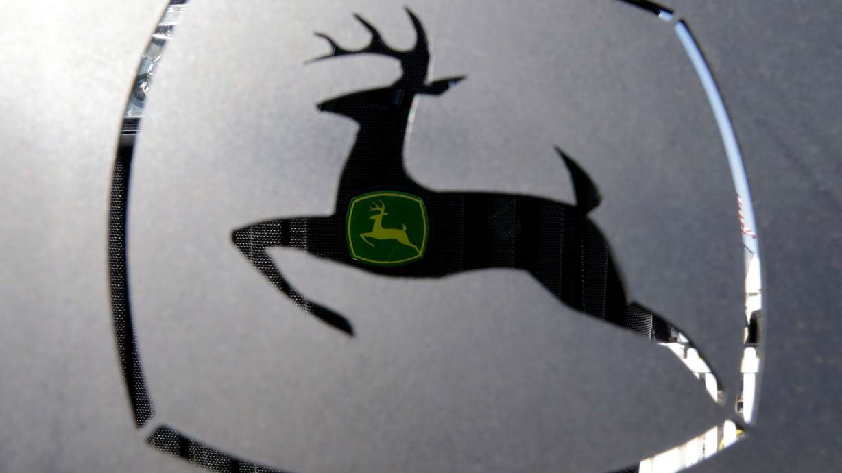 A John Deer emblem is seen at the Husker Harvest Days farm show in Wood River, Neb., Sept. 12, 2018. It looks like John Deere owners can soon feel free to fix their own machines.