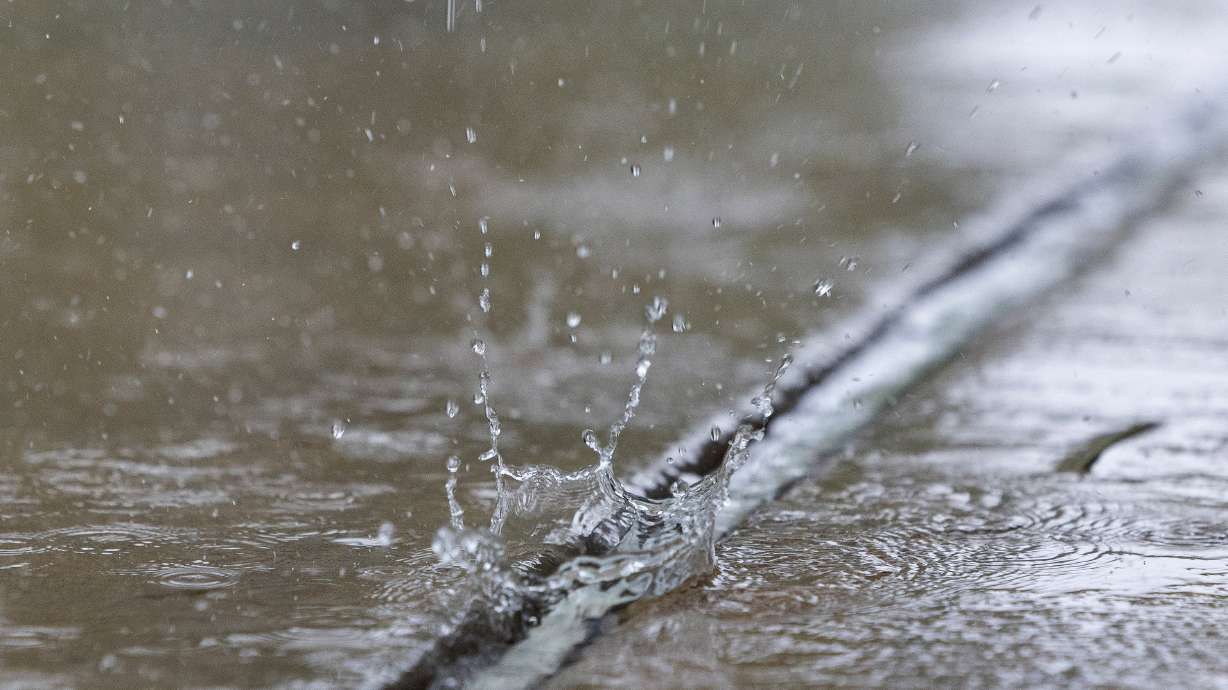 Rain falls into a puddle in Salt Lake City on April 26. Extreme heat is forecast for Utah this weekend, but long-range models indicate monsoonal moisture could develop as early as next week in Utah.