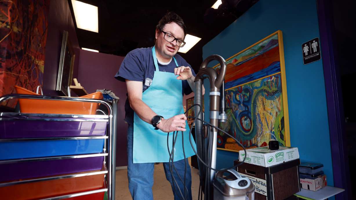 Tony LeFevre wraps up the cord after vacuuming as he volunteers at Jump the Moon art studio in Logan on Tuesday. It is one of a few regular volunteer jobs LeFevre does through Cache Employment and Training Center.