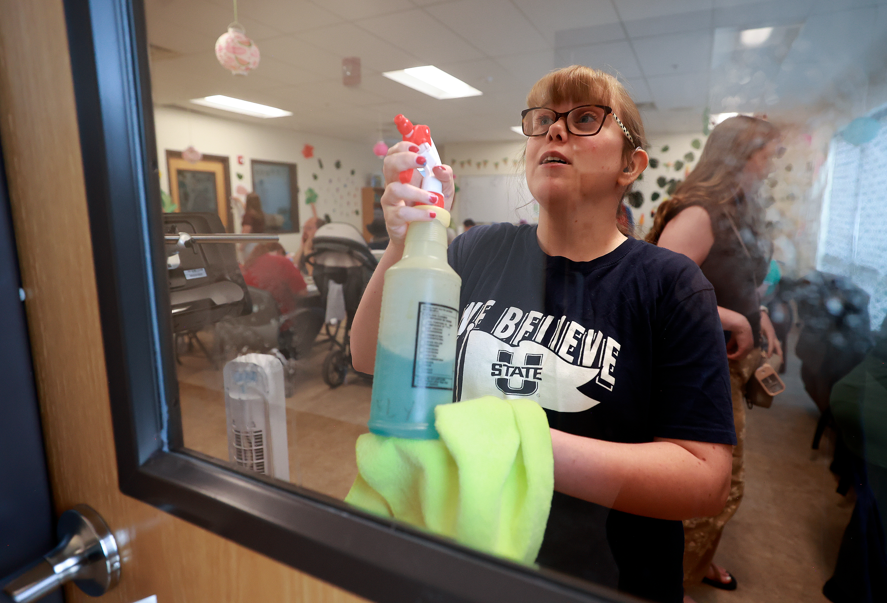 Sarah Hoggan, 29, cleans a window at Cache Employment and Training Center in Logan on Tuesday.