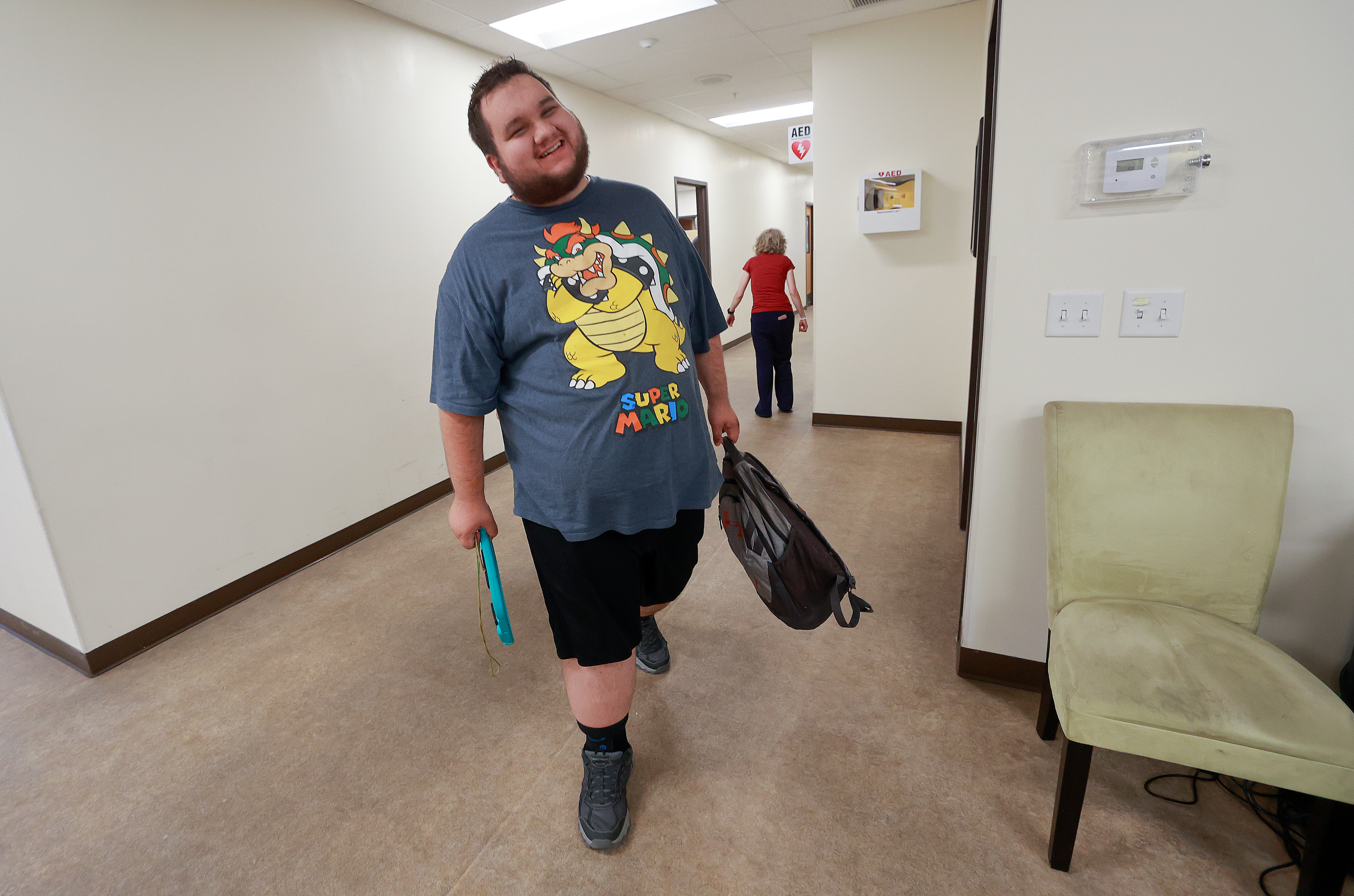 Stephen Frandsen, who is nonverbal, carries his backpack as he leaves the Cache Employment and Training Center in Logan at the end of the day on Tuesday.