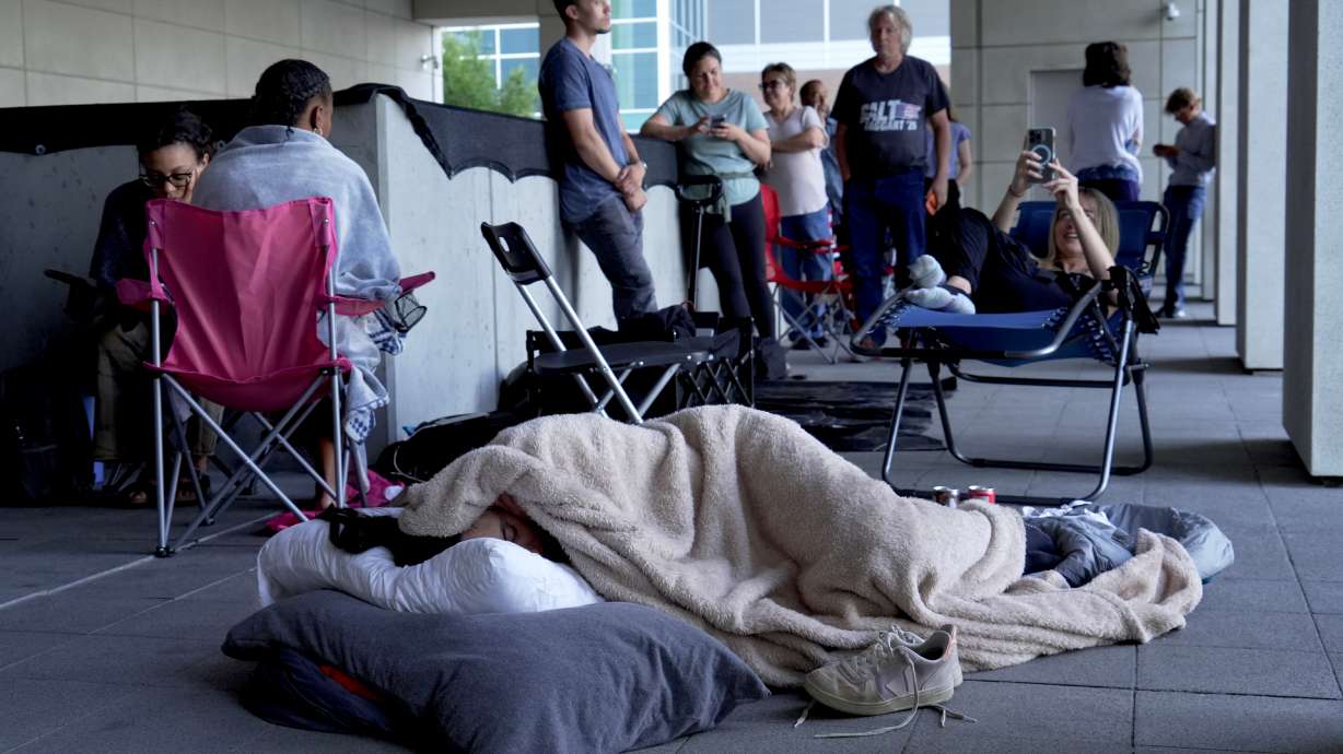 A woman sleeps outside the Provo courthouse Thursday in hopes to get access to the limited public seating available at a preliminary hearing for Tyler Robinson, the Utah man accused of fatally shooting Charlie Kirk.