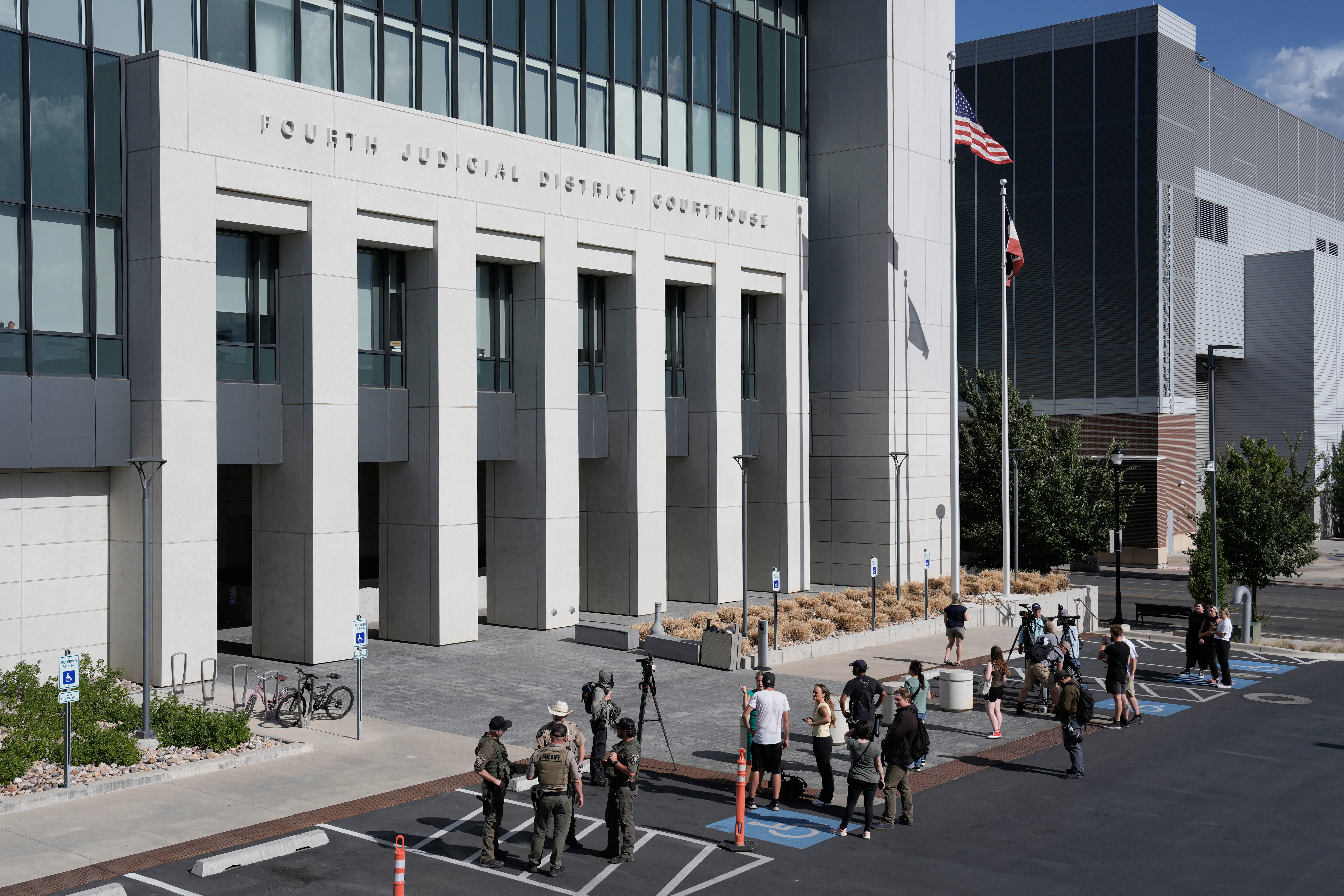 People stand outside the 4th District Courthouse in Provo, Tuesday, after a hearing for Tyler Robinson.