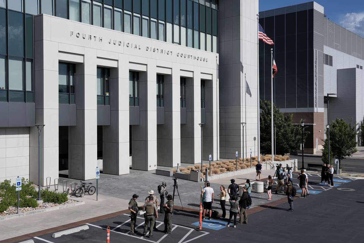 People stand outside the 4th District Courthouse in Provo, Tuesday, after a hearing for Tyler Robinson.
