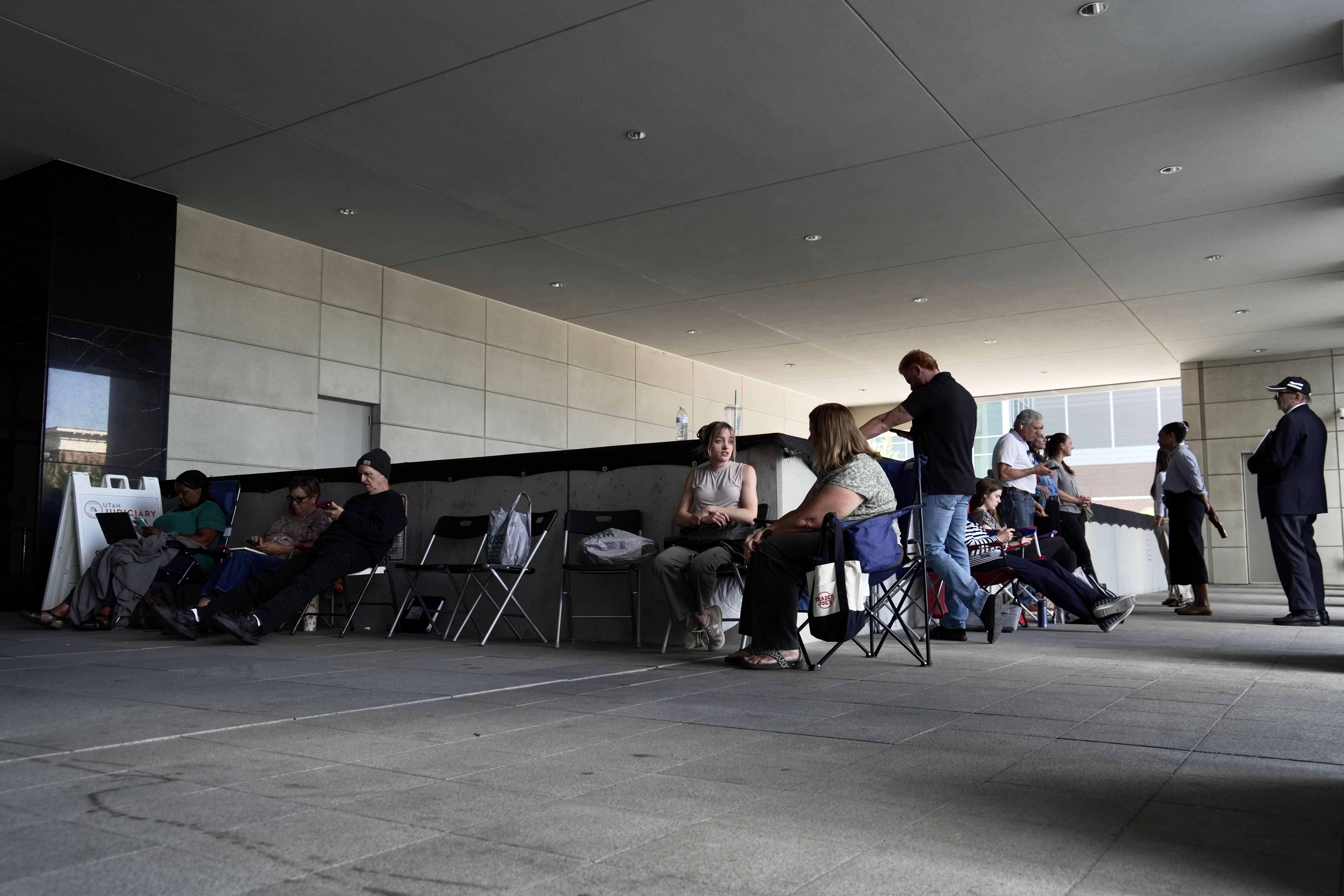 A line forms for people looking to access limited public seating available at a preliminary hearing for Tyler Robinson, in Provo, Wednesday.