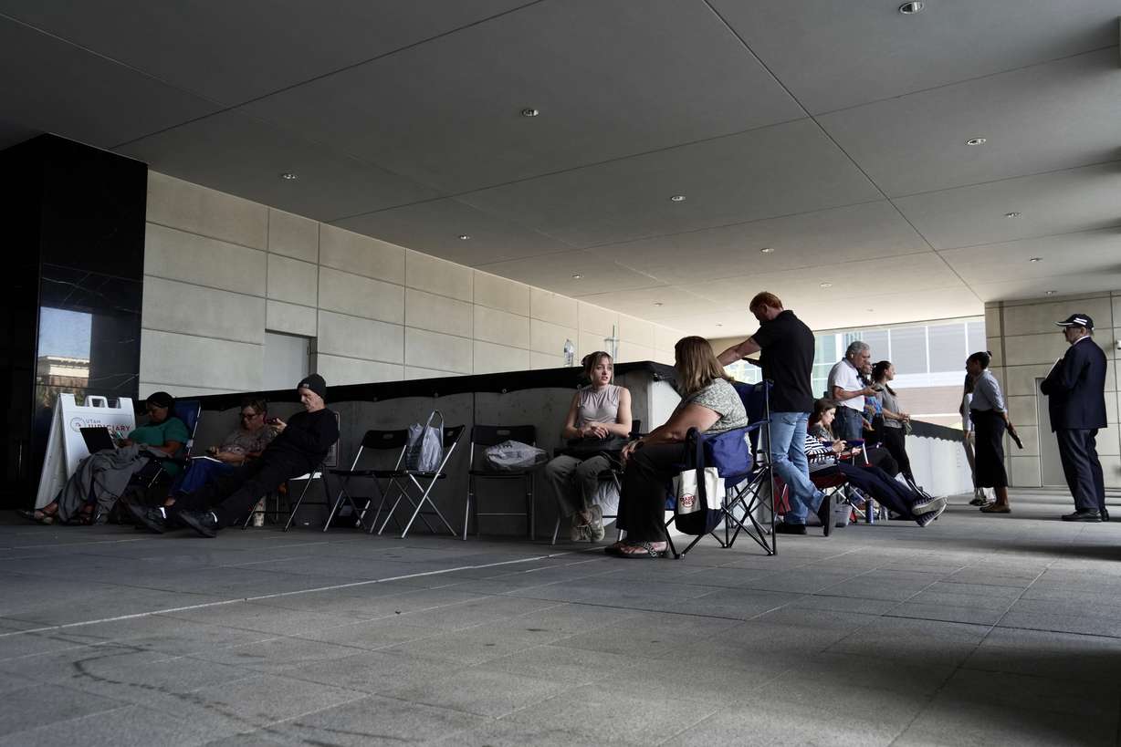 A line forms for people looking to access limited public seating available at a preliminary hearing for Tyler Robinson, in Provo, Wednesday.