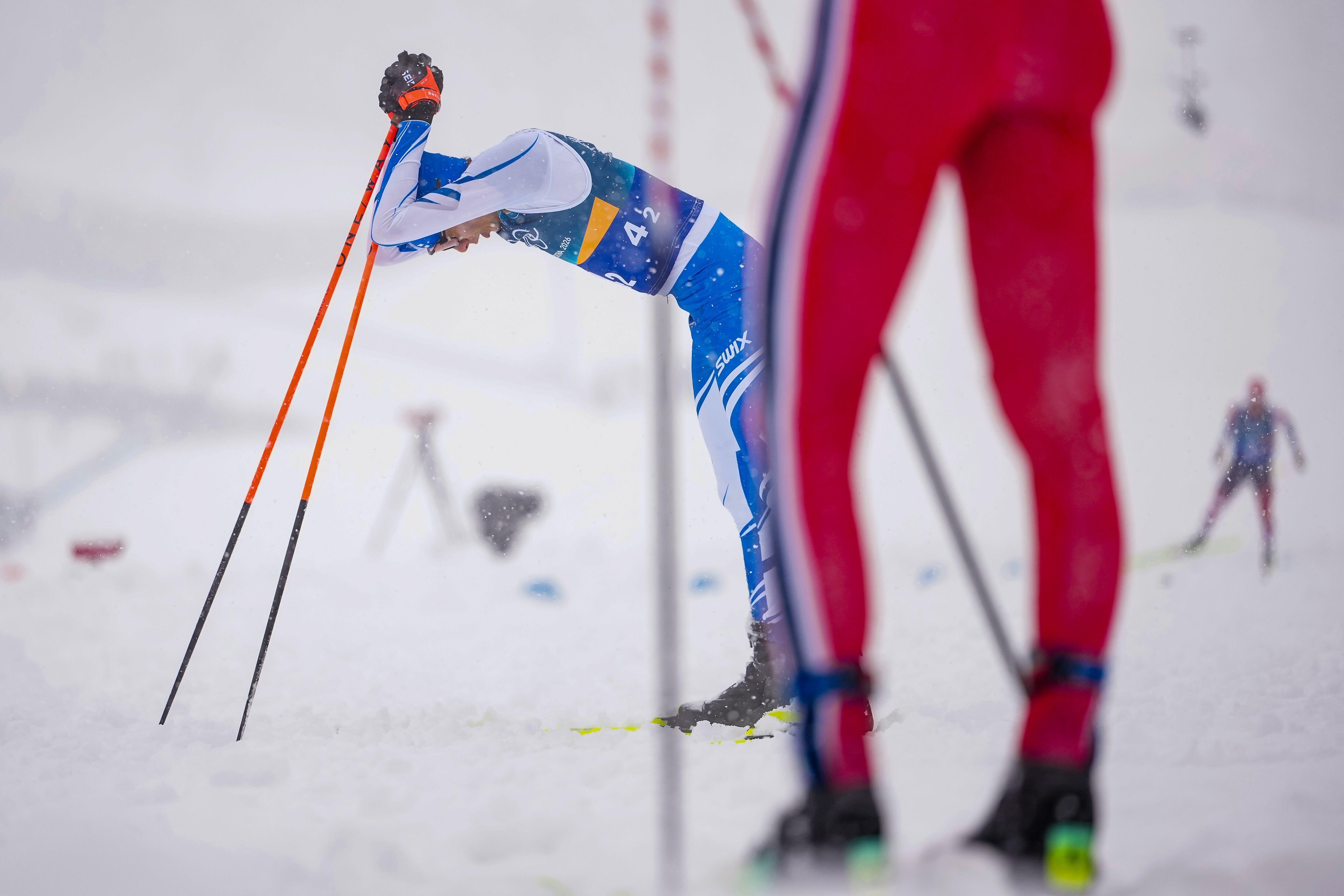 Eero Hirvonen, of Finland, reacts after crossing the finish line to win the silver medal in the nordic combined team sprint at the 2026 Winter Olympics, in Tesero, Italy, Feb. 19.