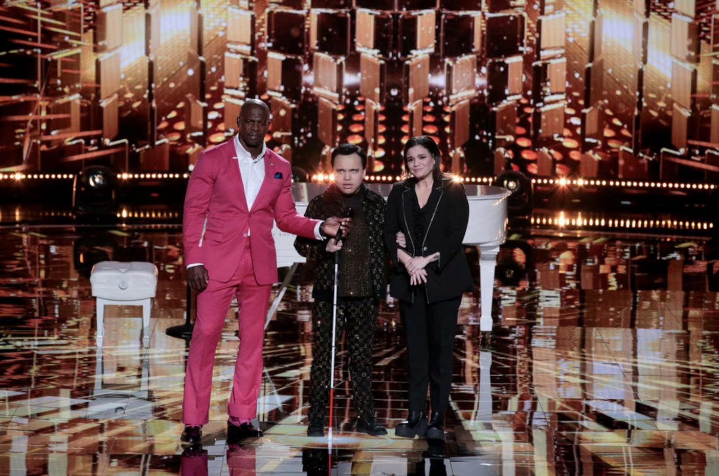 “AGT: Fantasy League” host Terry Crews stands with Kodi Lee and his mom, Tina Lee.