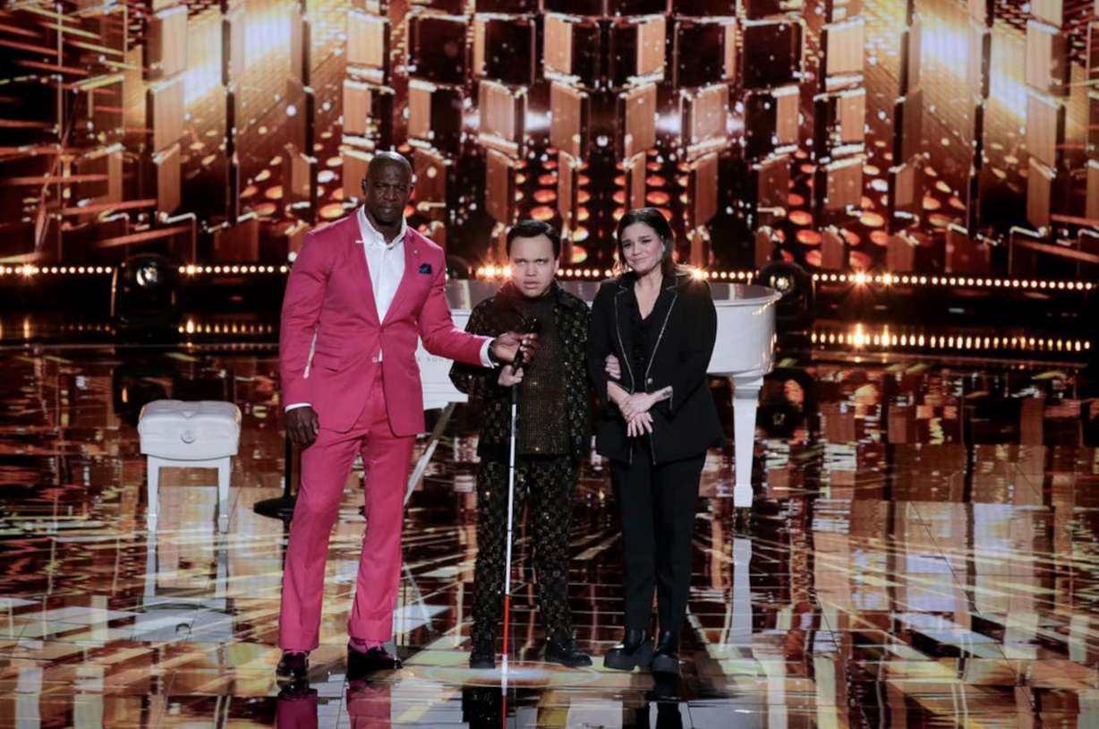 “AGT: Fantasy League” host Terry Crews stands with Kodi Lee and his mom, Tina Lee.