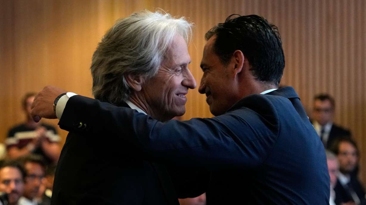 Jorge Jesus, left, is embraced by Portuguese Federation President Jorge Proenca after being presented to the media as the new Portugal soccer head coach at the Portuguese Football Federation in Oeiras, outside Lisbon, Friday, July 10, 2026.