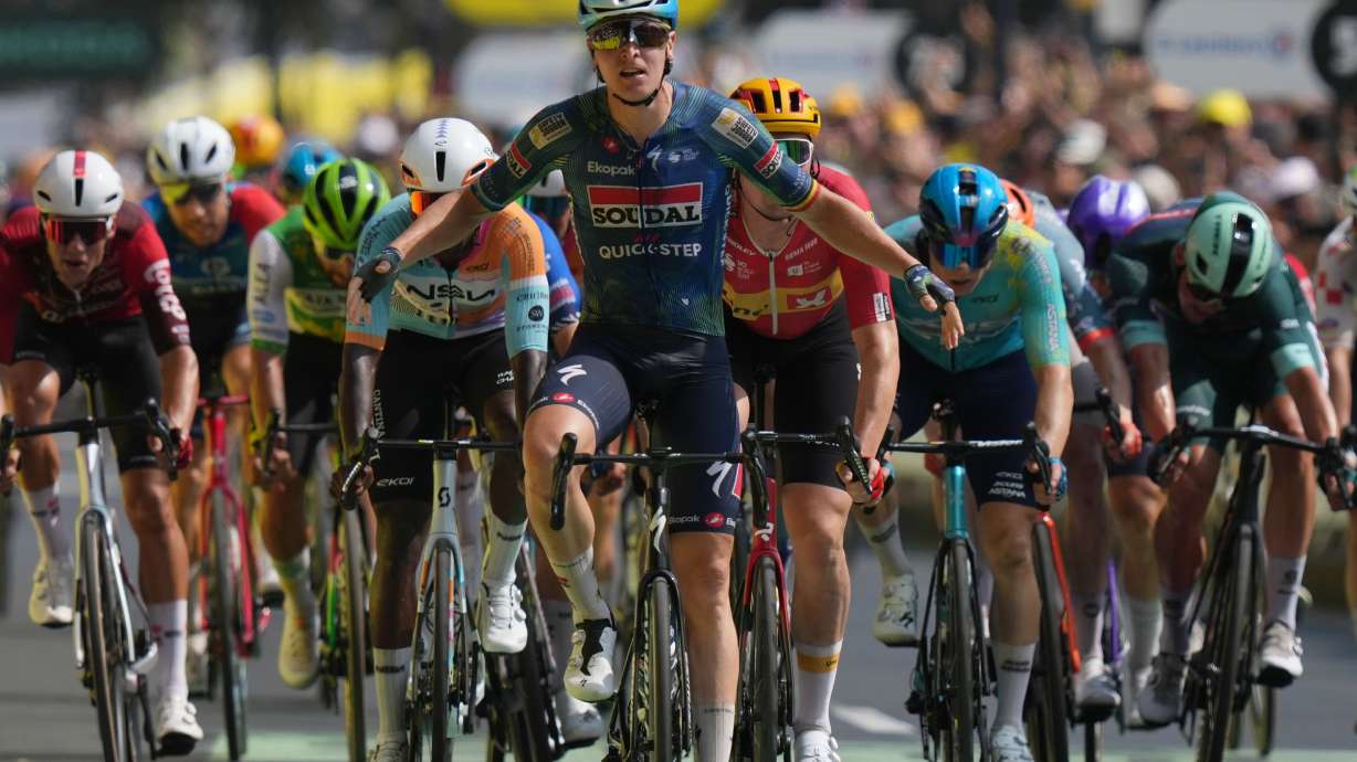 Belgium's Tim Merlier celebrates as he crosses the finish line to win the seventh stage of the Tour de France cycling race with start in Hagetmau and finish in Bordeaux, France, Friday, July 10, 2026.