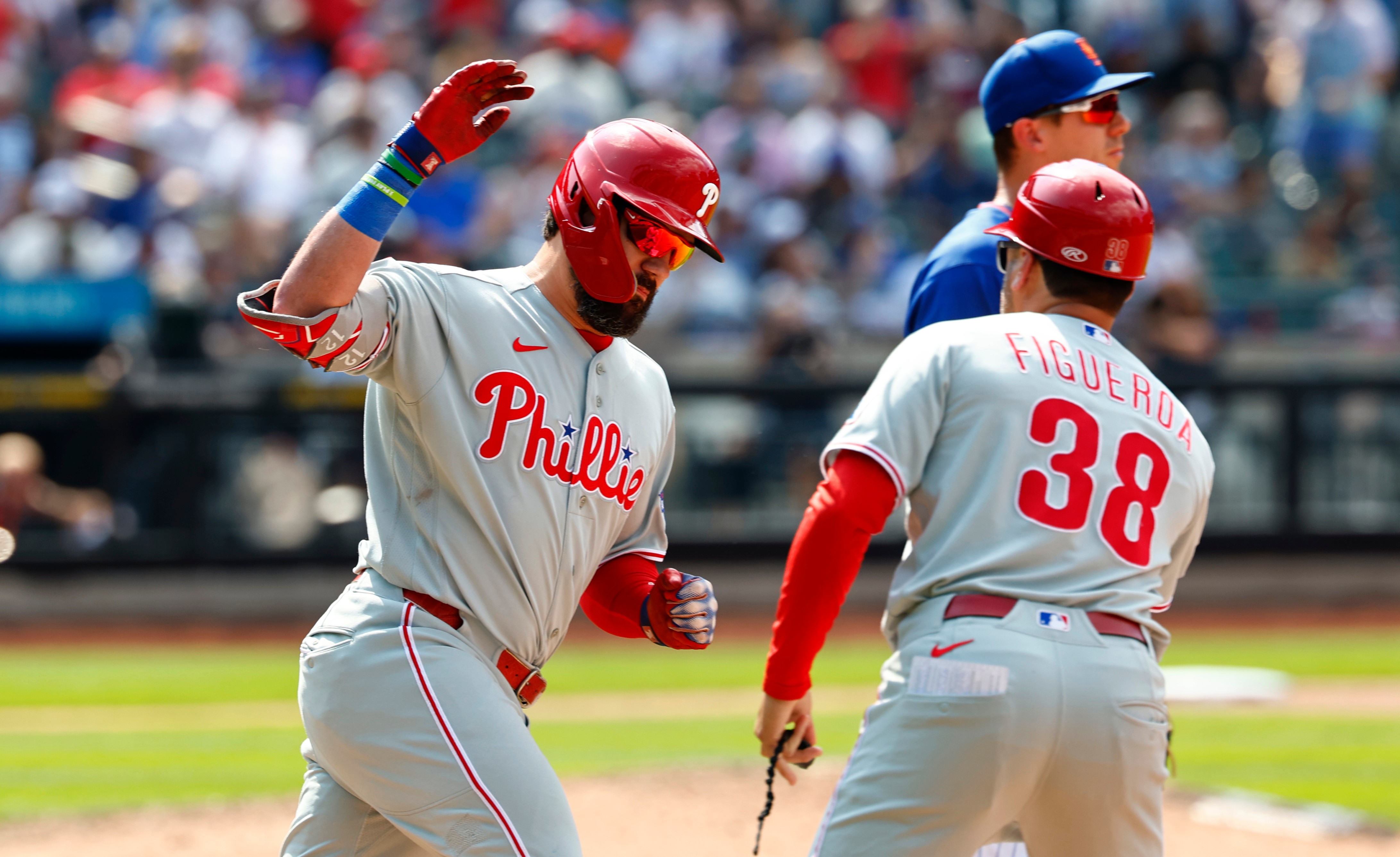 Philadelphia Phillies' Kyle Schwarber, left, celebrates with first base coach Paco Figueroa (38) after hitting a two-run home run against the New York Mets during the seventh inning of a baseball game, Sunday, June 28, 2026, in New York. 