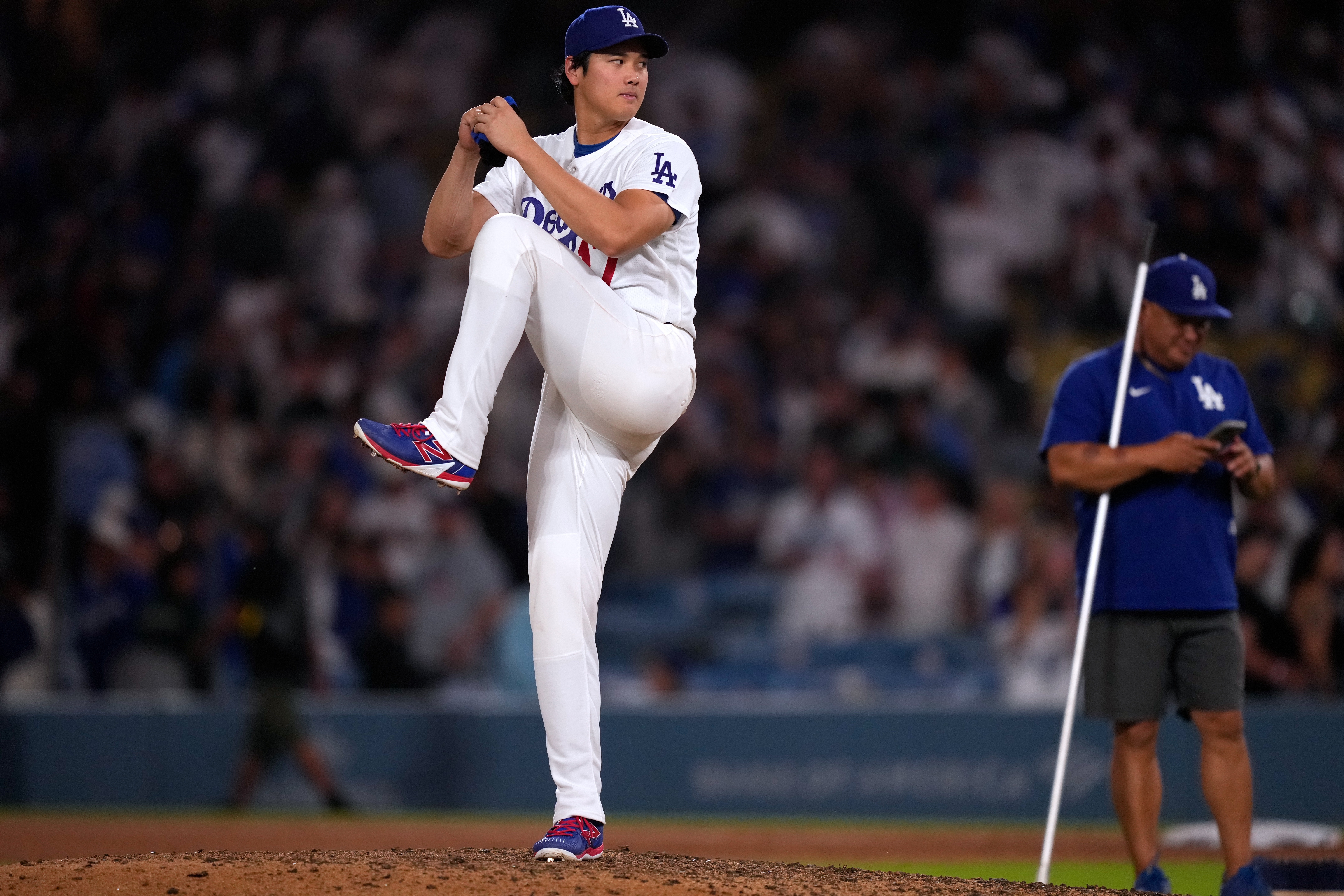 Los Angeles Dodgers' Shohei Ohtani fakes a pitch after the Dodgers defeated the against the Colorado Rockies in a baseball game Wednesday, July 8, 2026, in Los Angeles. 