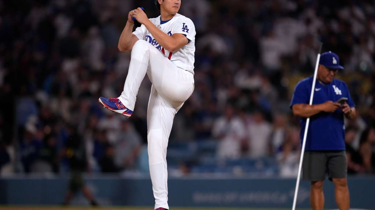 Los Angeles Dodgers' Shohei Ohtani fakes a pitch after the Dodgers defeated the against the Colorado Rockies in a baseball game Wednesday, July 8, 2026, in Los Angeles.