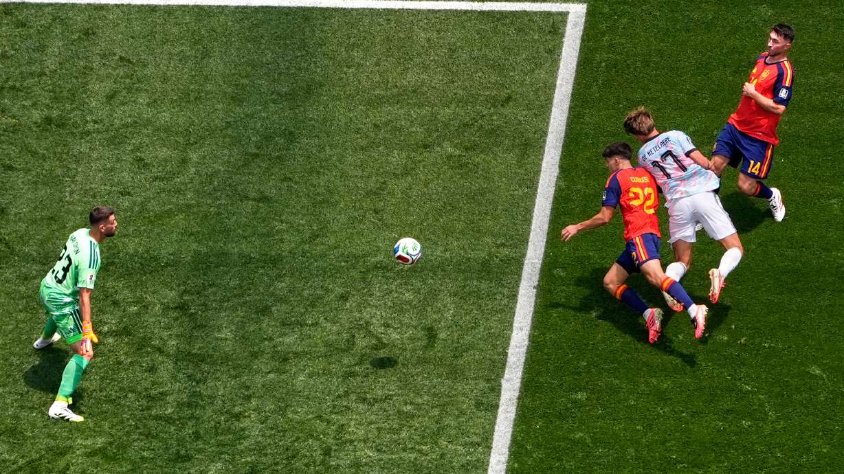 Belgium's Charles De Ketelaere (17) scores their opening goal past Spain goalkeeper Unai Simon (23) during the World Cup quarterfinal soccer match between Spain and Belgium in Inglewood, Calif., near Los Angeles, Friday, July 10, 2026.
