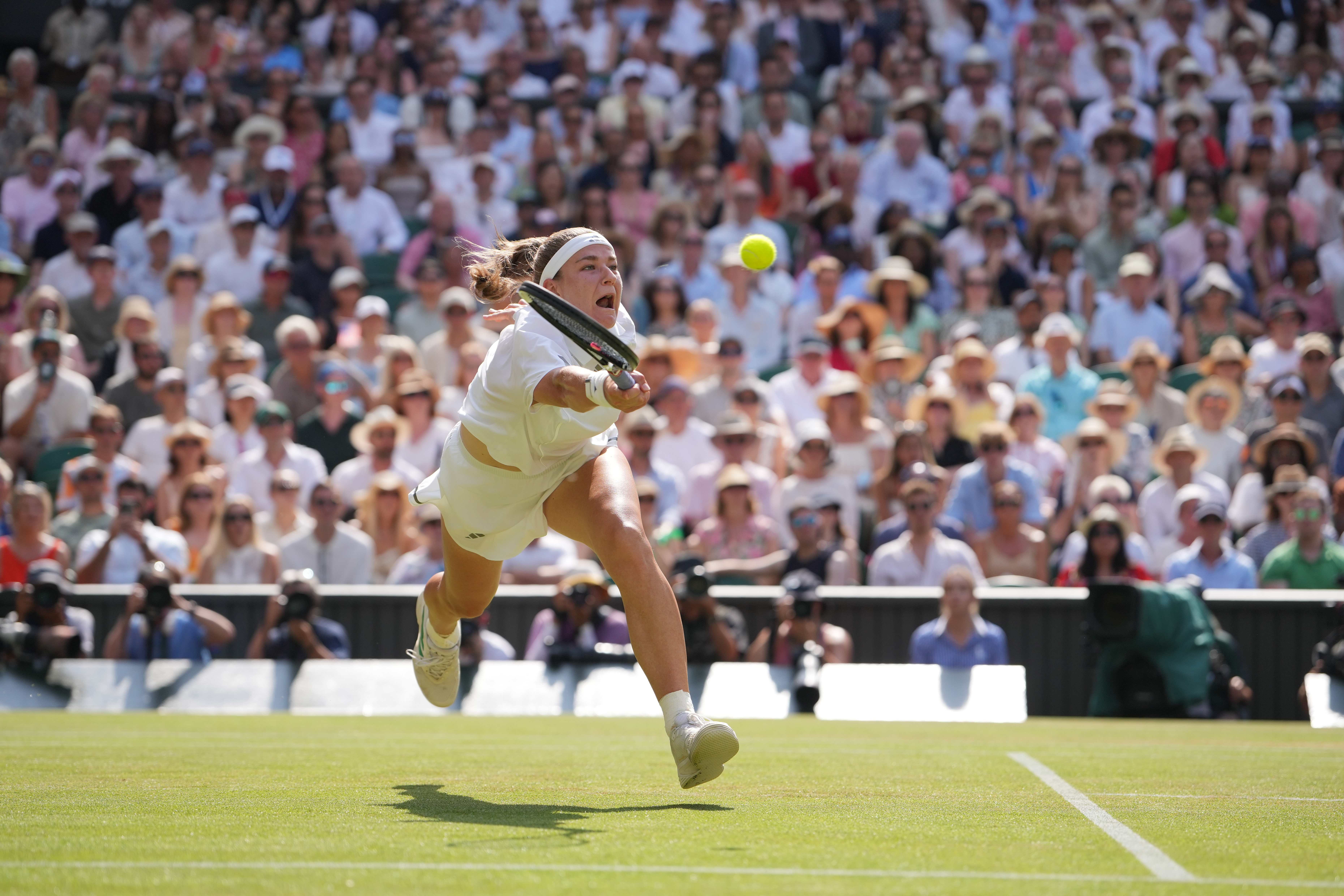 Karolina Muchova of the Czech Republic returns the ball to Coco Gauff of the United States celebrates a point against in their semifinal women's singles match at the Wimbledon Tennis Championships in London, Thursday, July 9, 2026. 