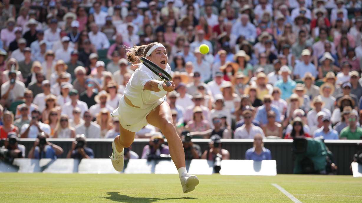 Karolina Muchova of the Czech Republic returns the ball to Coco Gauff of the United States celebrates a point against in their semifinal women's singles match at the Wimbledon Tennis Championships in London, Thursday, July 9, 2026.