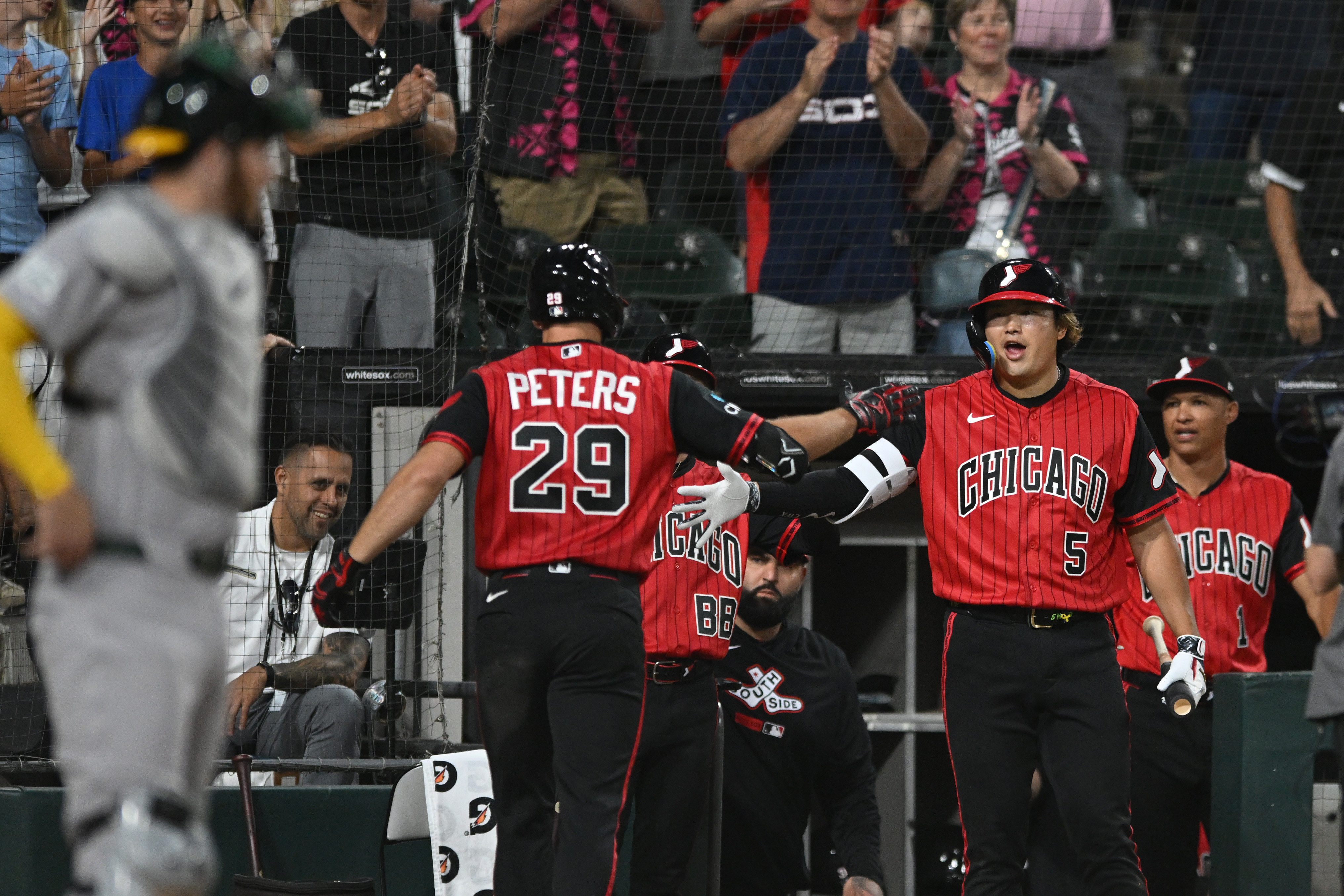 Chicago White Sox's Tristan Peters (29) celebrates with teammate Munetaka Murakami (5) at the dugout after hitting a two-run home run during the seventh inning of a baseball game against The Athletics in Chicago, Friday, July 10, 2026. 