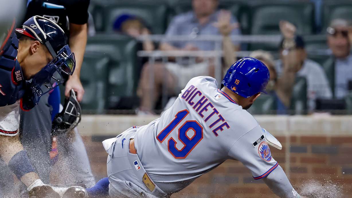 Atlanta Braves catcher Drake Baldwin, left, tags out New York Mets' Bo Bichette (19) at home plate during the sixth inning of a baseball game, Monday, July 6, 2026, in Atlanta.