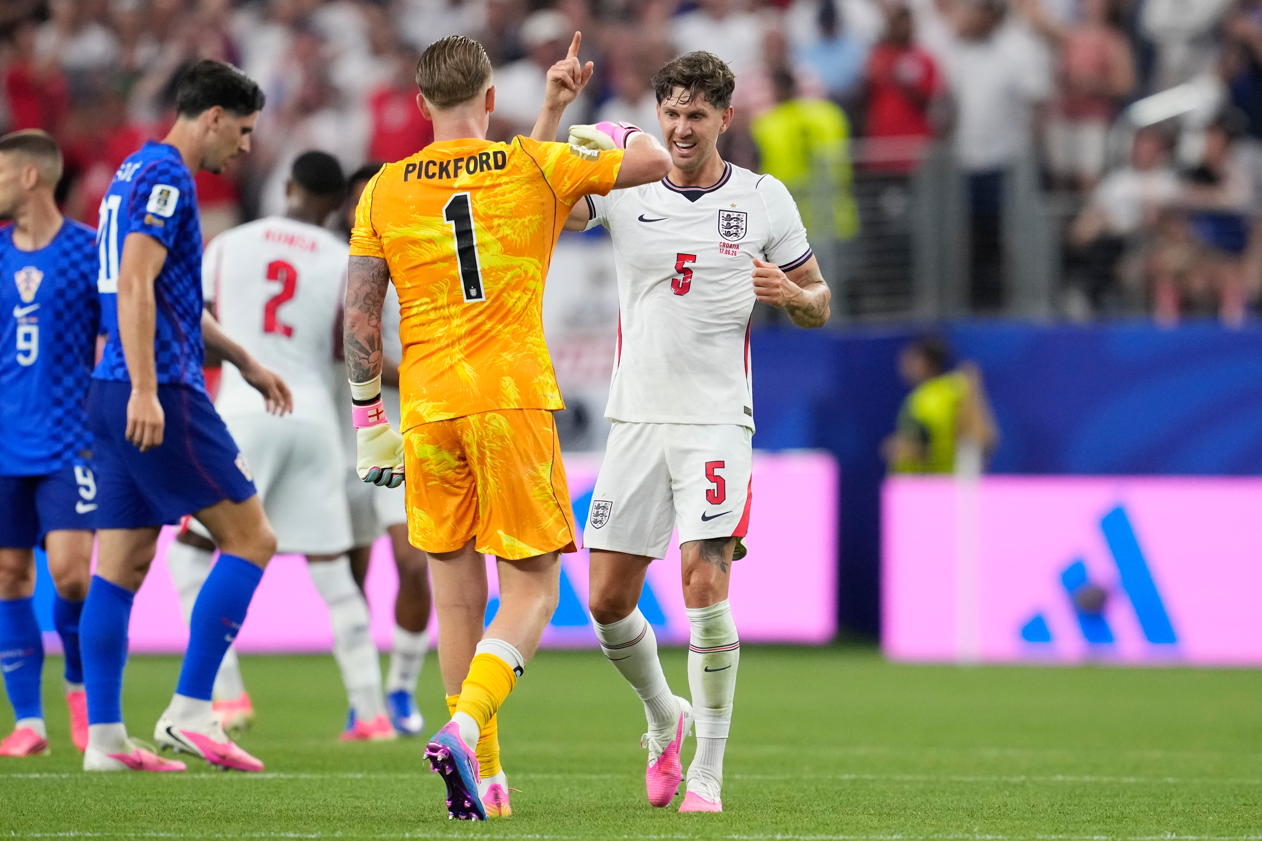 England's John Stones (5) and England goalkeeper Jordan Pickford (1) celebrate their team's fourth goal by England's Marcus Rashford during the World Cup Group L soccer match between England and Croatia in Arlington, Texas, near Dallas, Wednesday, June 17, 2026. 