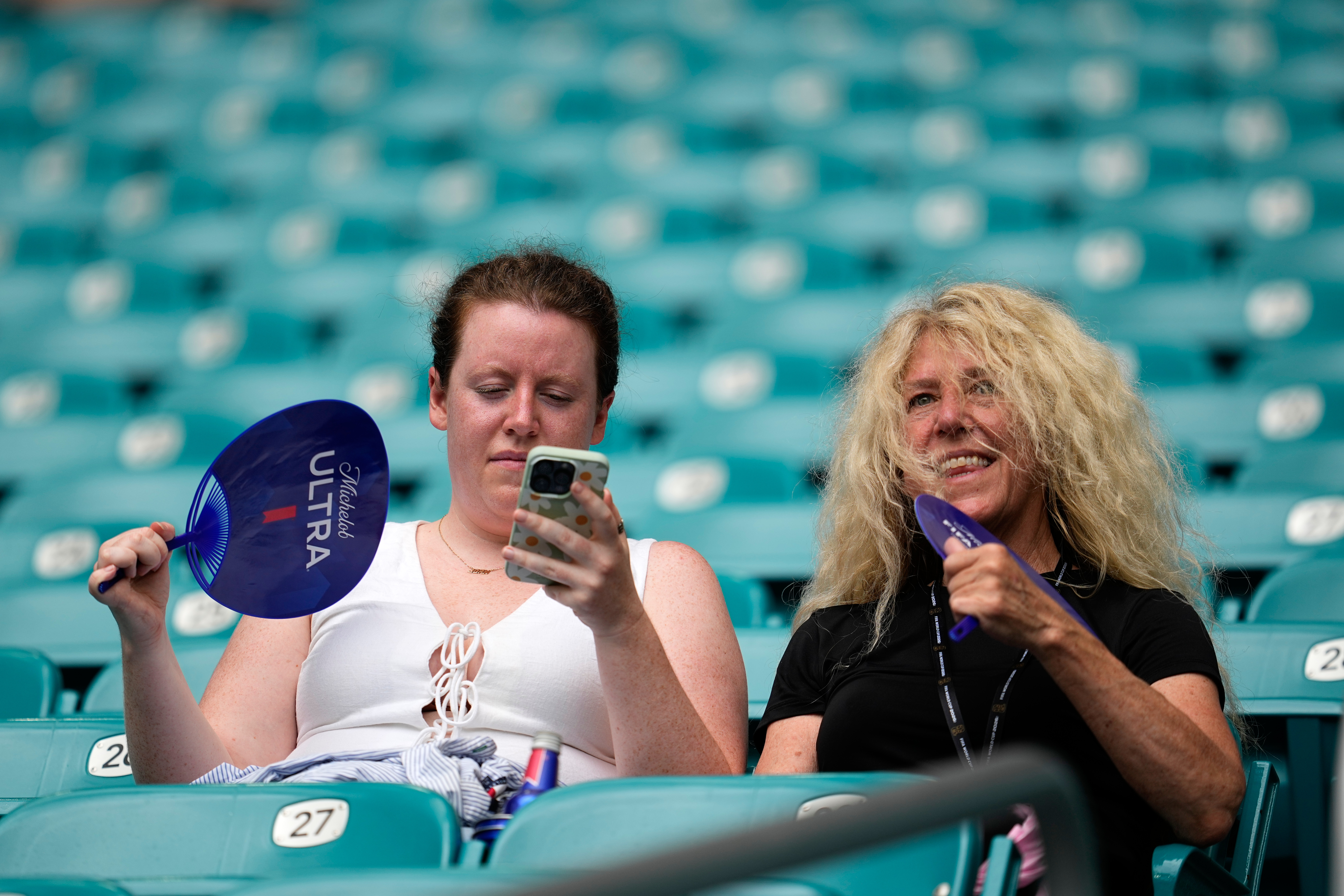 Spectators fan themselves before the World Cup quarterfinal soccer match between Norway and England in Miami Gardens, Fla., Saturday, July 11, 2026. 