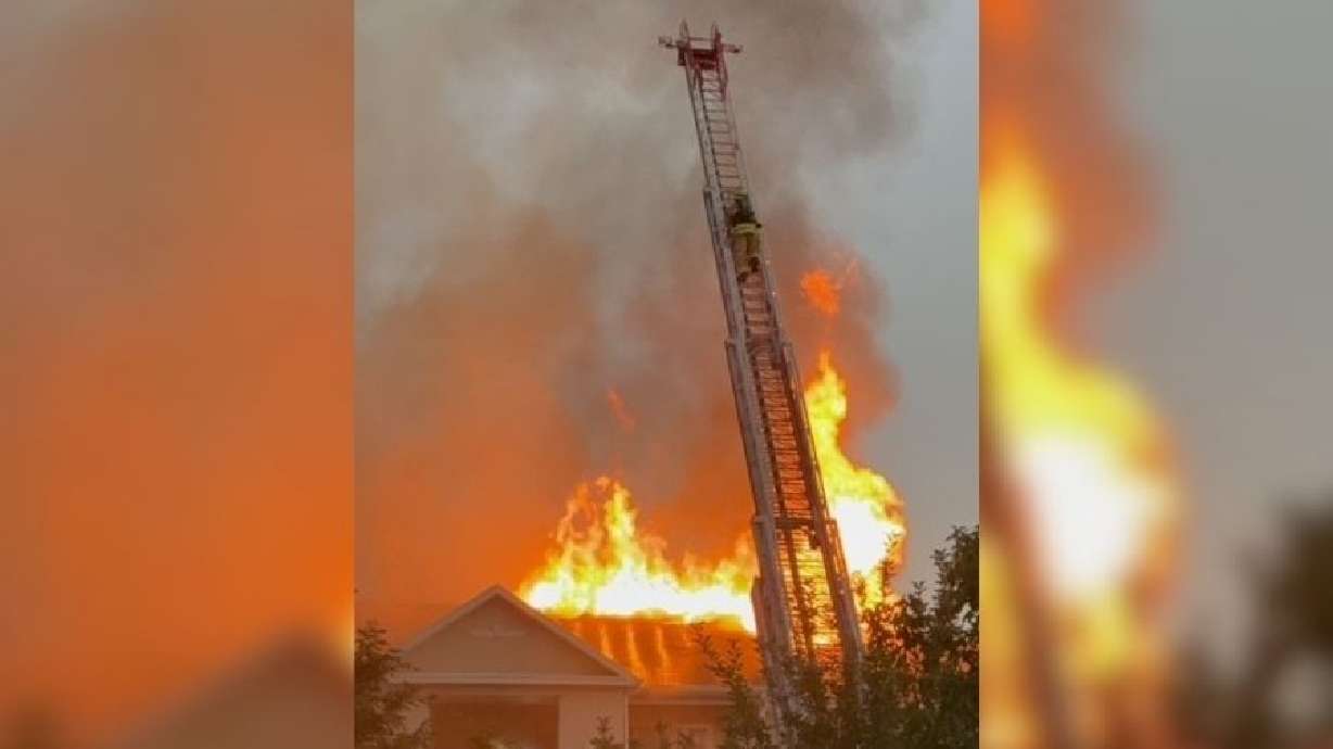 A firefighter battles flames coming from a West Jordan apartment building on Friday. The building was later determined to be uninhabitable.