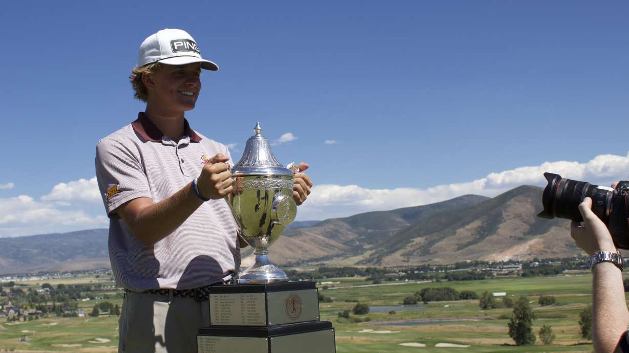 Arizona State rising sophomore Bowen Mauss of Draper looks at the trophy after winning the 128th Utah state amateur championship, Saturday, July 11, 2026 at Soldier Hollow Golf Course in Midway.