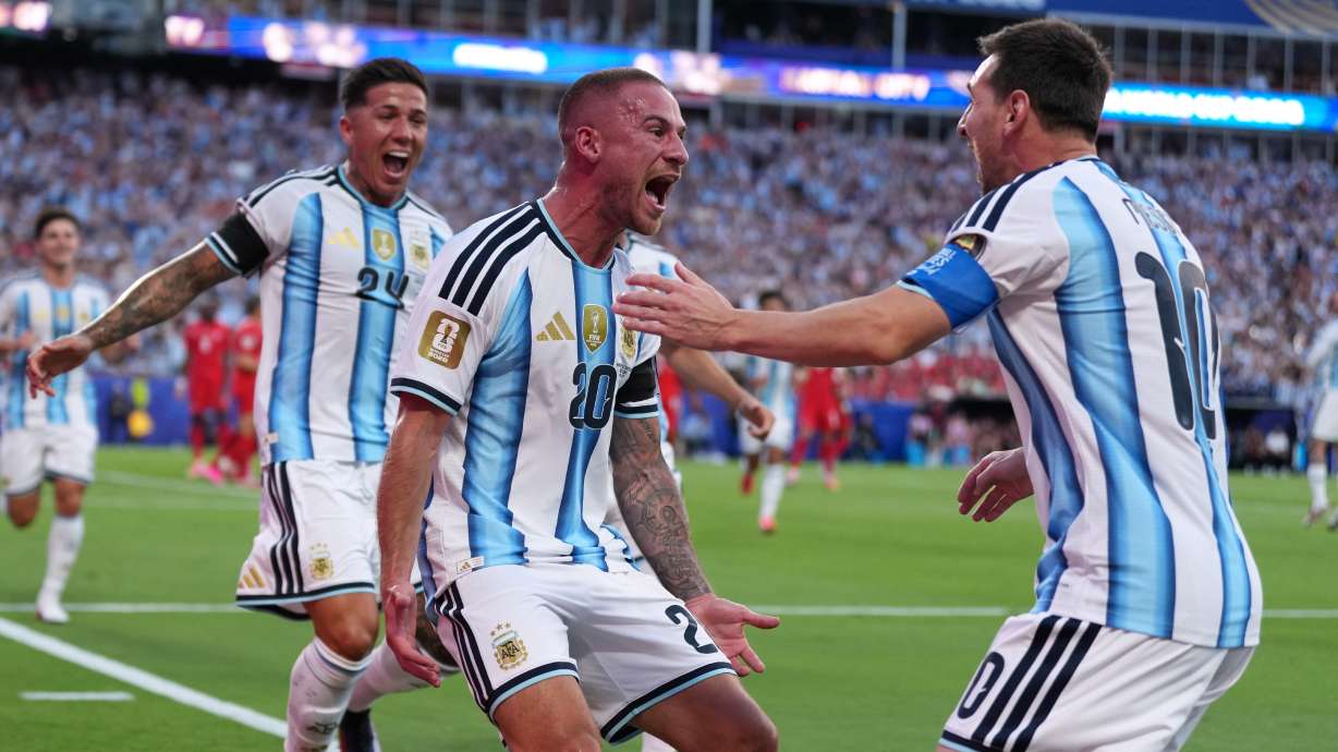 Argentina's Alexis Mac Allister, center, celebrates scoring their first goal with Lionel Messi during the World Cup quarterfinal soccer match between Argentina and Switzerland in Kansas City, Mo., Saturday, July 11, 2026.