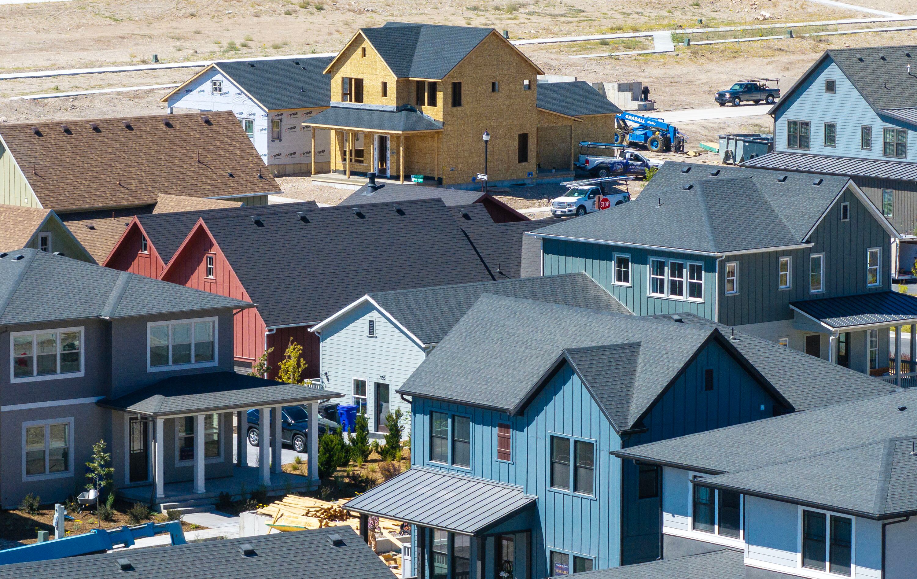 Workers build homes in West Jordan on Aug. 11, 2025.
