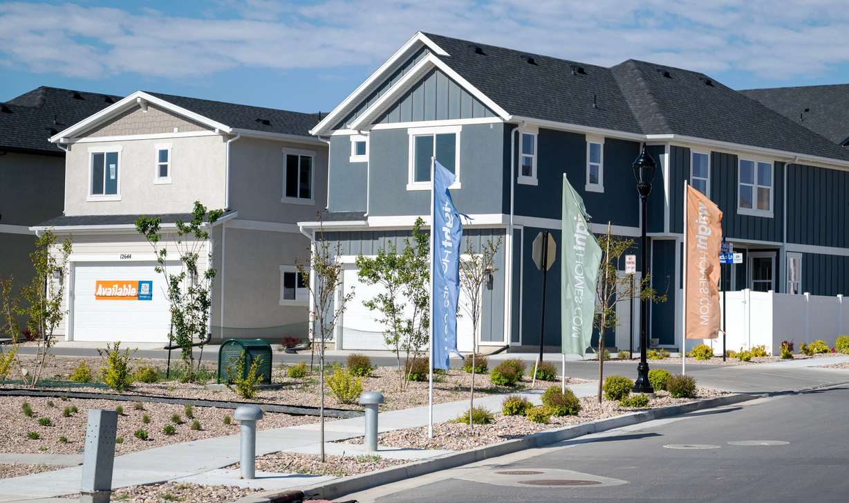 "Available" signs are seen in front of a model home in Herriman on May 12.