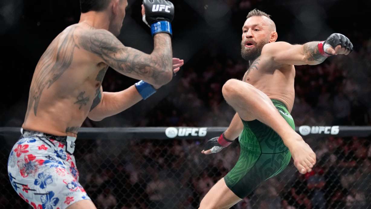 Conor McGregor, right, jumps into the air for a kick as he fights Max Holloway in a welterweight fight at the UFC 329 mixed martial arts event Saturday, July 11, 2026, in Las Vegas.