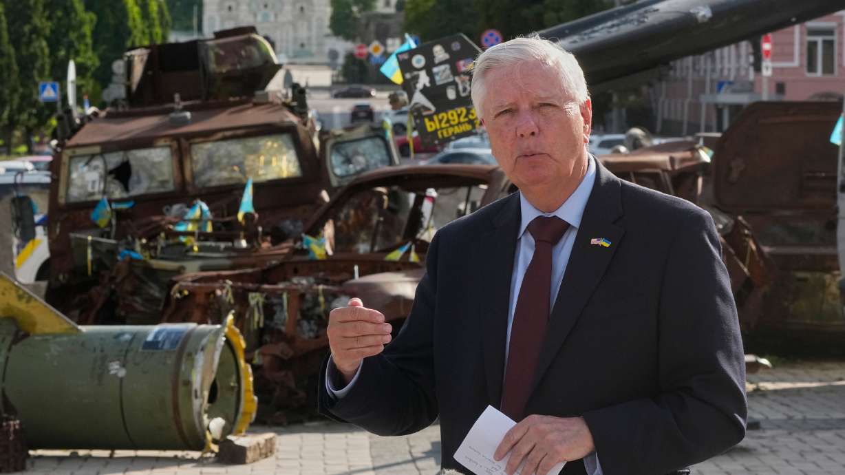 Sen. Lindsey Graham, R-S.C., answers media questions near damaged Russian vehicles exhibition in central Kyiv, Ukraine, on Friday. He died Saturday night after a brief and unexpected illness, his office said.
