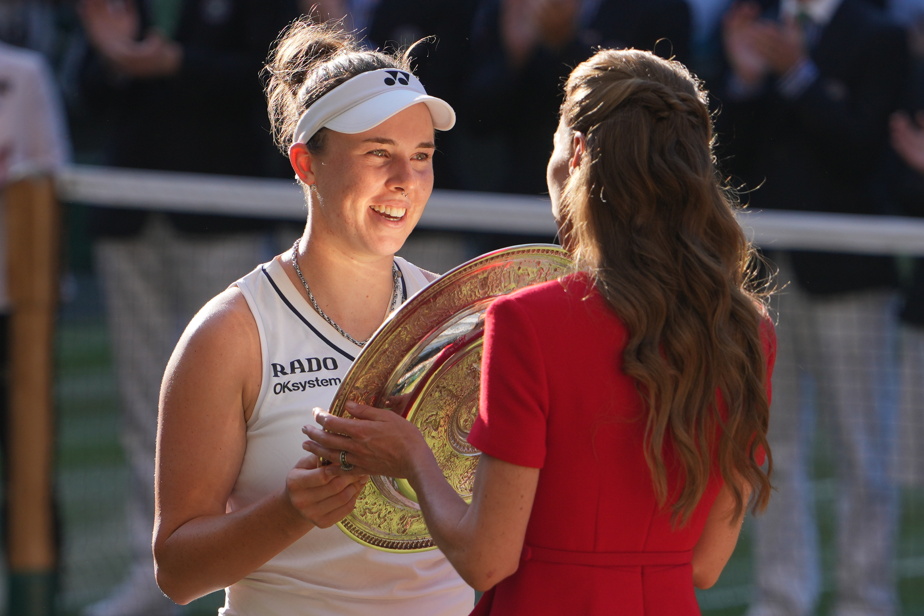 Linda Noskova of Czech Republic receives the champion trophy from Britain's Princess Kate after defeating Karolina Muchova of Czech Republic the women's singles final at Wimbledon Tennis Championships in London, Saturday, July 11, 2026. 