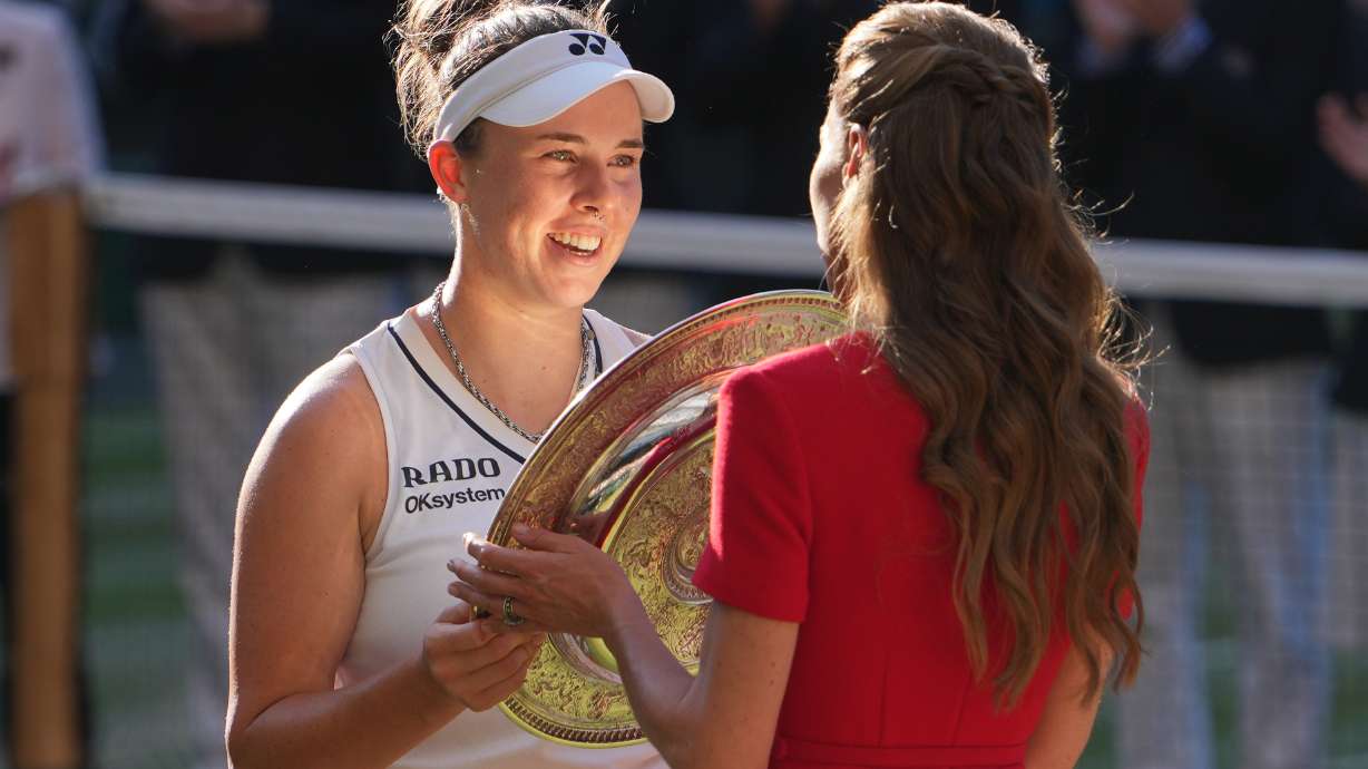 Linda Noskova of Czech Republic receives the champion trophy from Britain's Princess Kate after defeating Karolina Muchova of Czech Republic the women's singles final at Wimbledon Tennis Championships in London, Saturday, July 11, 2026.