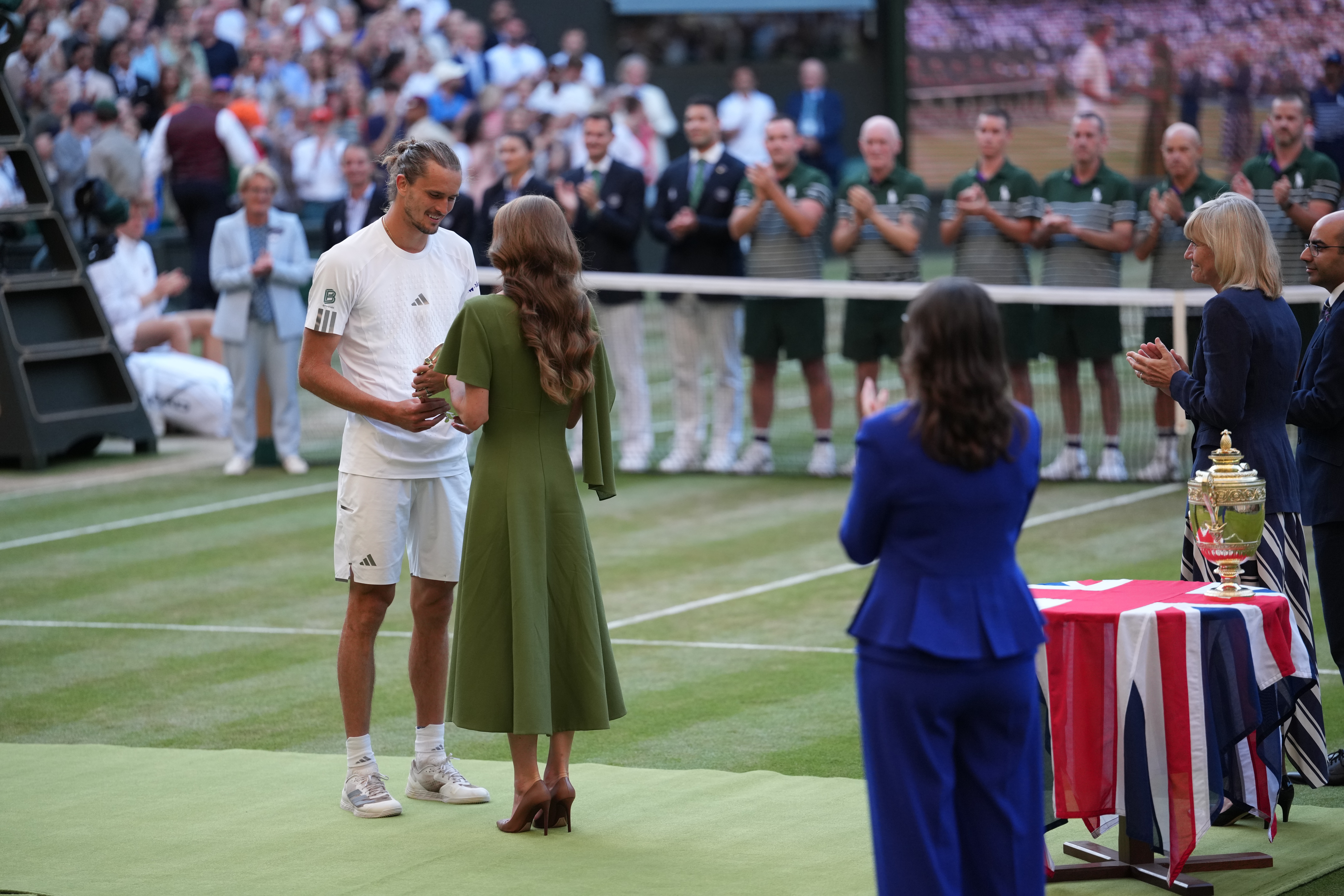 Britain's Princess Kate presents the runner-up trophy to Alexander Zverev of Germany after his match against Jannik Sinner of Italy in the men's singles final at Wimbledon Tennis Championships in London, Sunday, July 12, 2026. 