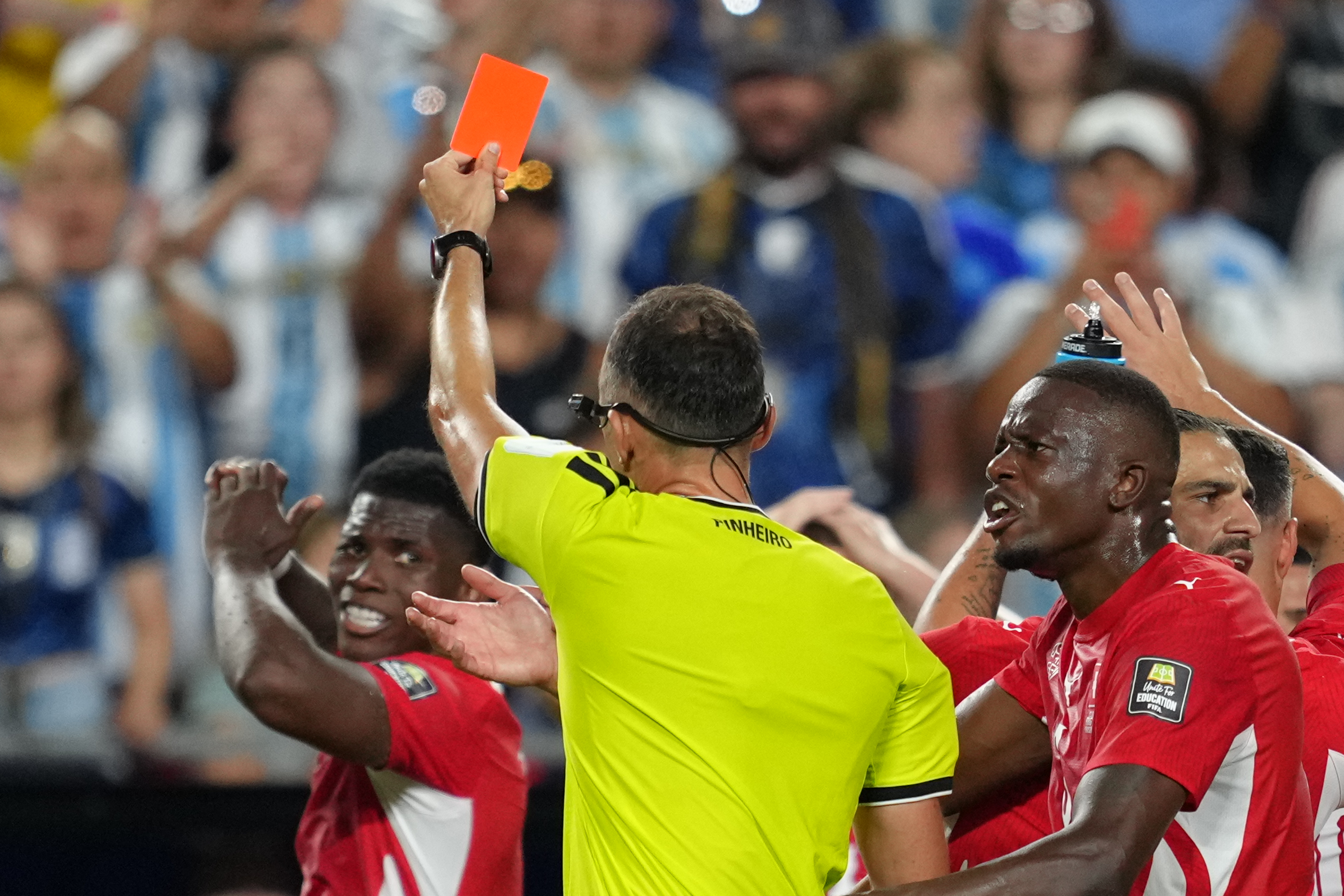 Referee Joao Pinheiro, of Portugal, gives a red card to Switzerland's Breel Embolo (7), left, during the World Cup quarterfinal soccer match between Argentina and Switzerland in Kansas City, Mo., Saturday, July 11, 2026. 
