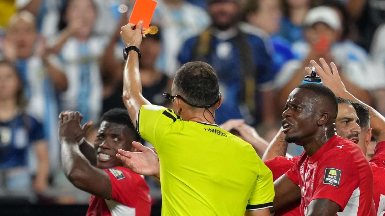 Referee Joao Pinheiro, of Portugal, gives a red card to Switzerland's Breel Embolo (7), left, during the World Cup quarterfinal soccer match between Argentina and Switzerland in Kansas City, Mo., Saturday, July 11, 2026.