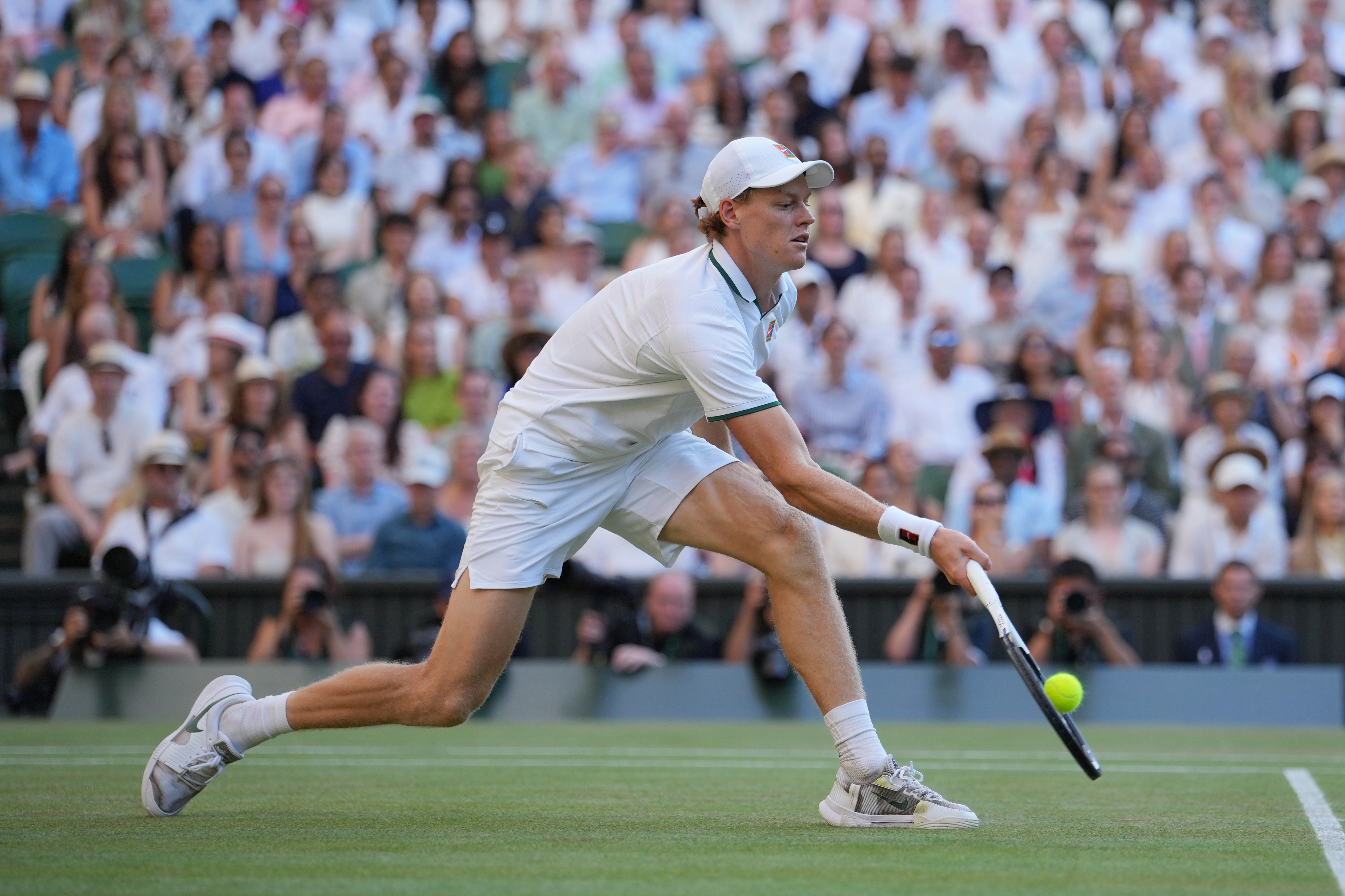 Jannik Sinner of Italy plays a return to Alexander Zverev of Germany during the men's singles final at Wimbledon Tennis Championships in London, Sunday, July 12, 2026. 