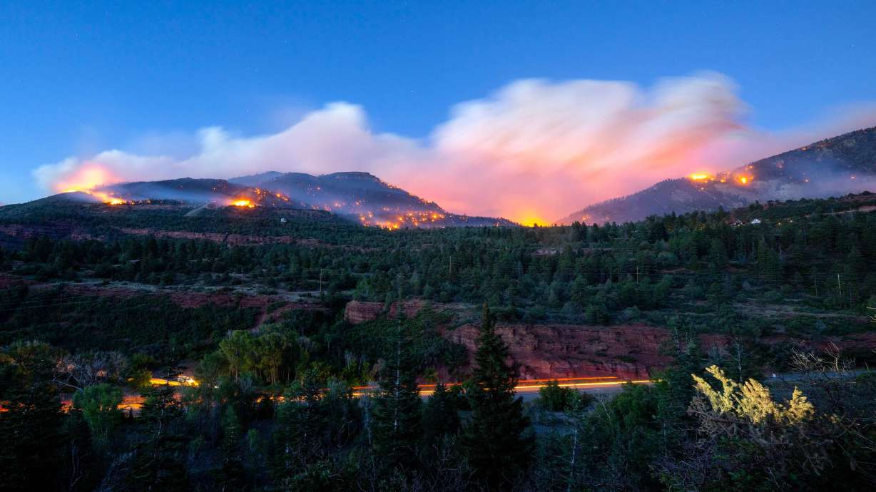 Firefighters drive along Highway 550 as they try to access the Gold Mountain Fire on the town line of Ouray and Ridgeway, Colo., on June 28.