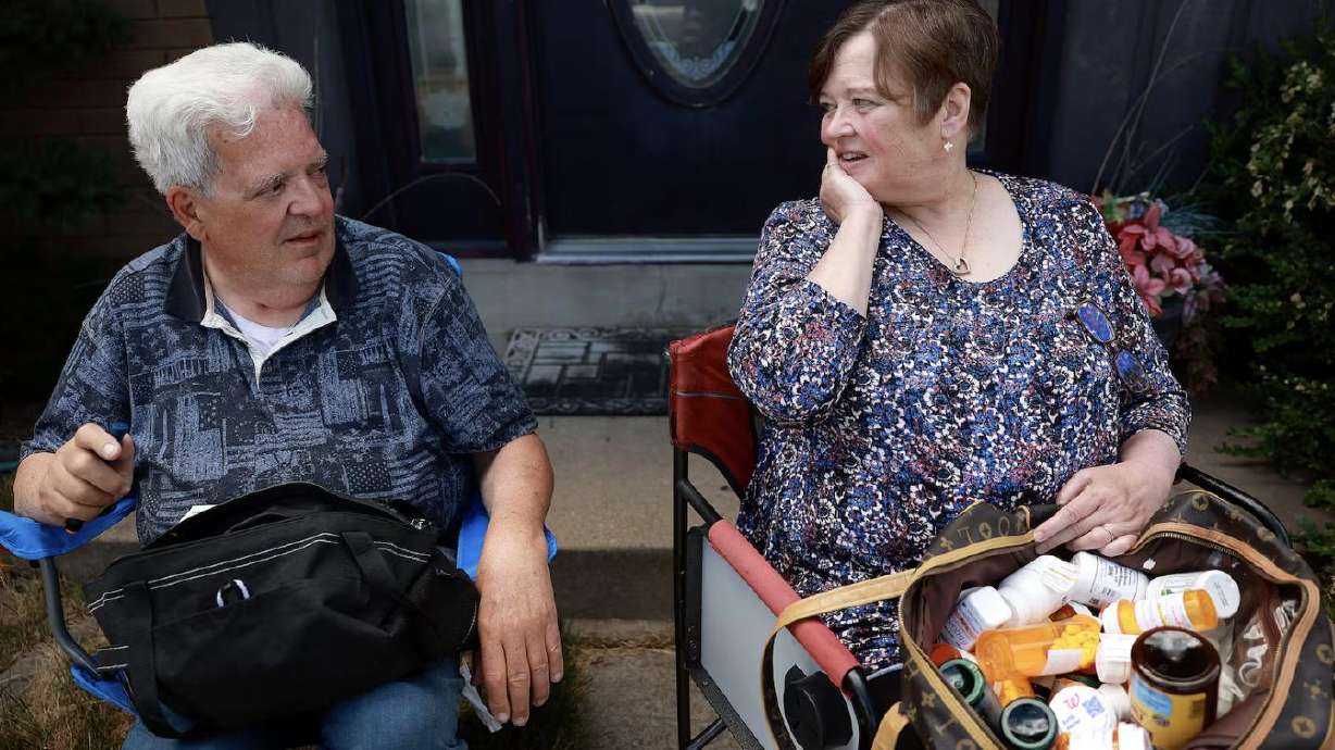 Doug and Sandy Lusty chat during a photoshoot in front of their home in Kaysville on July 1. Sandy has had to skip doses of prescription medication due to high costs. They each take more than a dozen prescription medications.