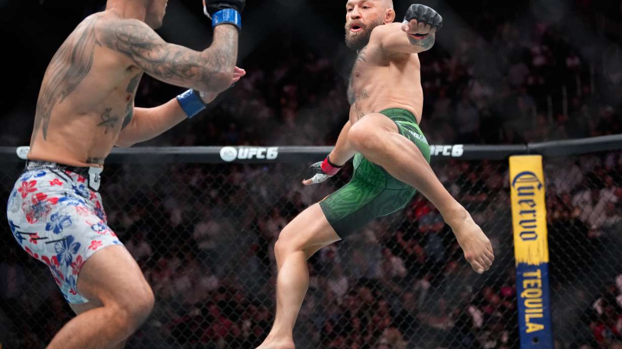 Conor McGregor, right, jumps into the air for a kick as he fights Max Holloway in a welterweight fight at the UFC 329 mixed martial arts event Saturday, July 11, 2026, in Las Vegas.