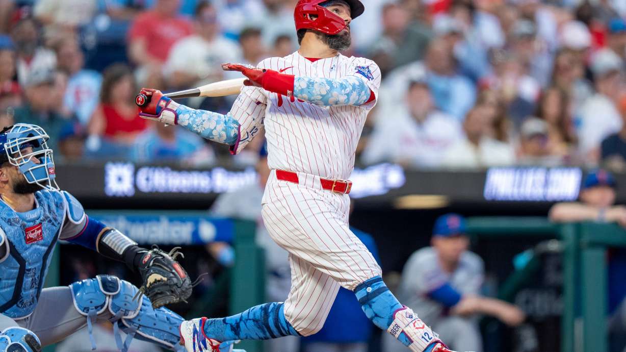 Philadelphia Phillies' Kyle Schwarber, right, hits a three-run home run during the second inning of a baseball game against the New York Mets, Sunday, June 21, 2026, in Philadelphia.