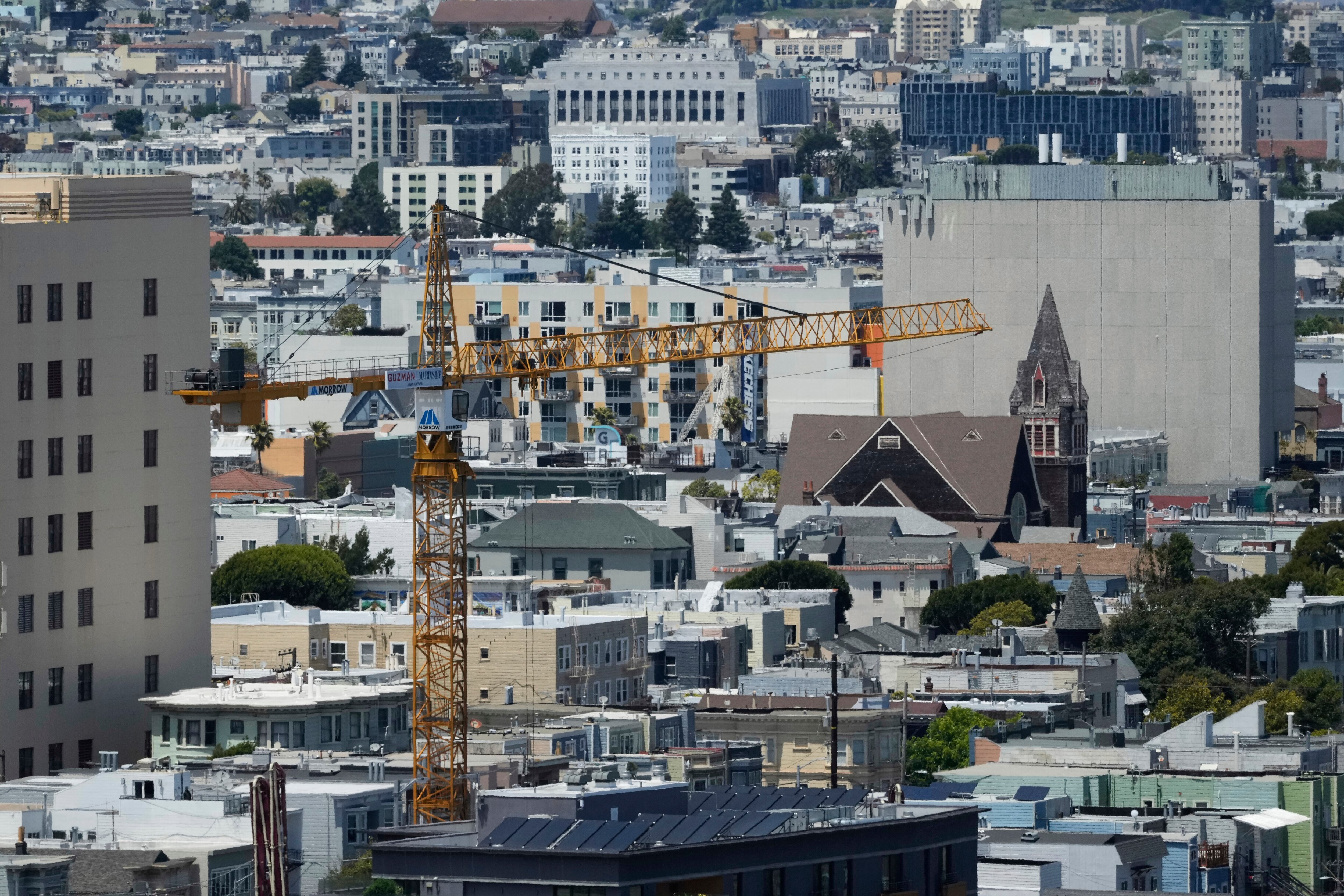 A crane rises over properties while being used at a construction site for a new housing development in San Francisco, July 18, 2025. Housing prices reached its highest level in San Francisco, according to a new Redfin analysis.